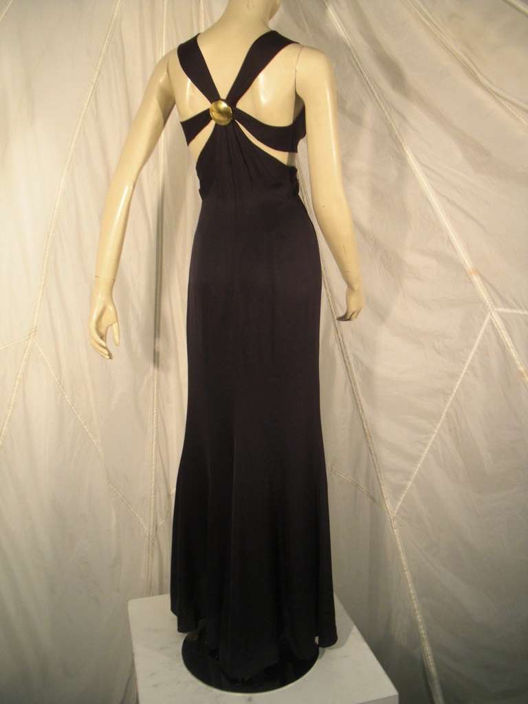 1990s Thierry Mugler couture black silk chiffon evening gown with gathered and sectioned midriff accented with a gold-tone metal medallion at front and back. Sexy bared back detail.  Fitted hip and fishtail hem. Lined in silk chiffon