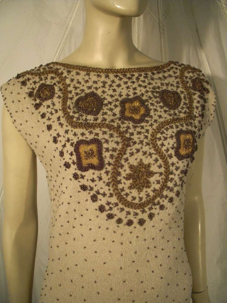 A fabulous 1960s Gene Shelley beige boucle knit cocktail dress, completely lined with heavily embellished bronze glass bead bodice and low-cut back. Back zipper.