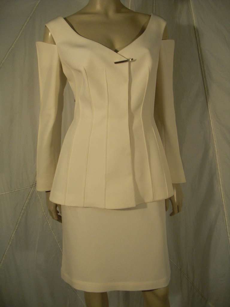 A gorgeous and sexy 1990s Thierry Mugler cream silk and acetate skirt suit with peek a boo shoulder construction, contour French welted seaming in jacket and single toggle-style closure.