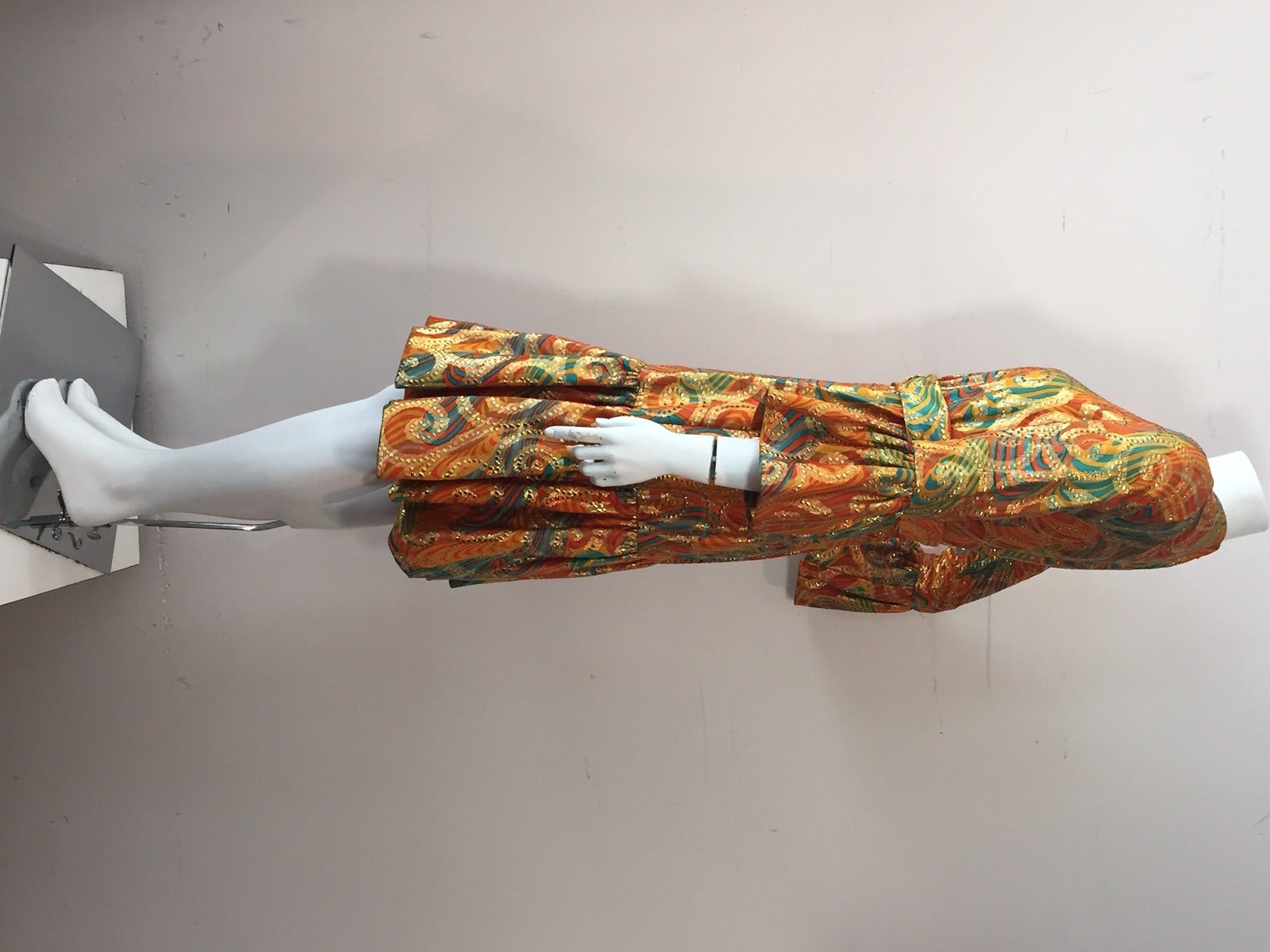 A gorgeous 1960s Roger Milot for Fred Perlberg autumnal lame paisley cocktail dress with wide ruffled hem and cuffs.  Matching belt.