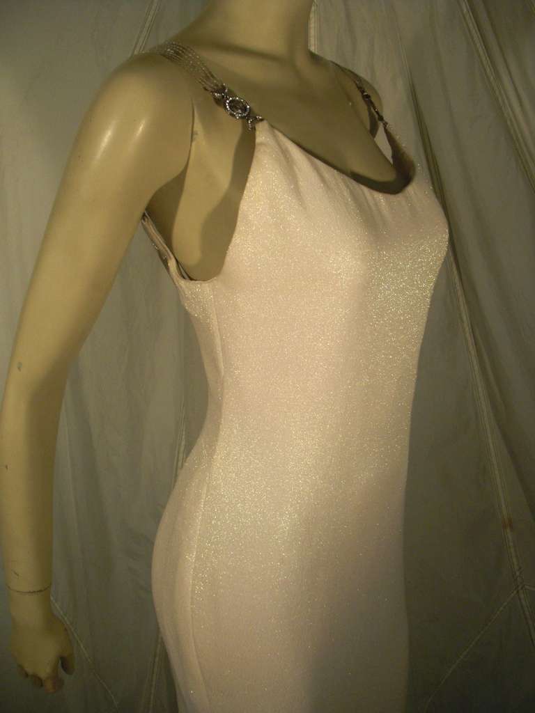 1980s Slinky, sexy Gianni Versace white silk and synthetic iridescent lame gown:  Low cut back with back center slit and exposed zipper. Signature Medusa medallions at clear vinyl straps re-enforced with stitching. Completely lined.