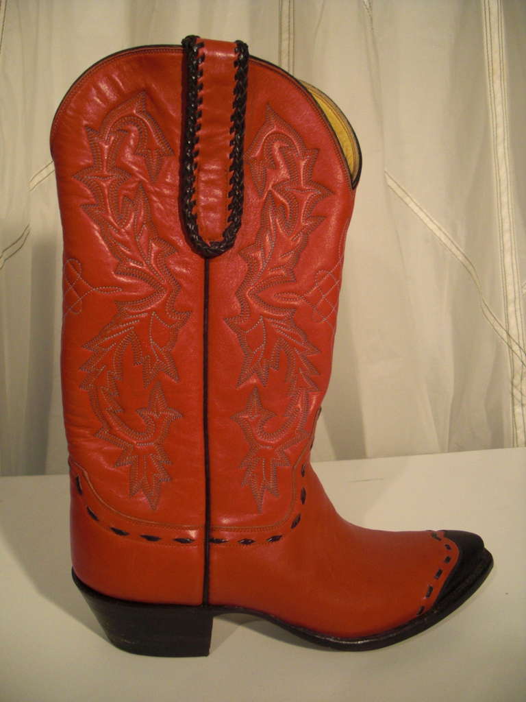 1980s wing-tip, pointed-toe, red leather Stallion brand boots with black leather hand stitching and pull straps.  Marked 6.5B. Could fit 6 with insoles.