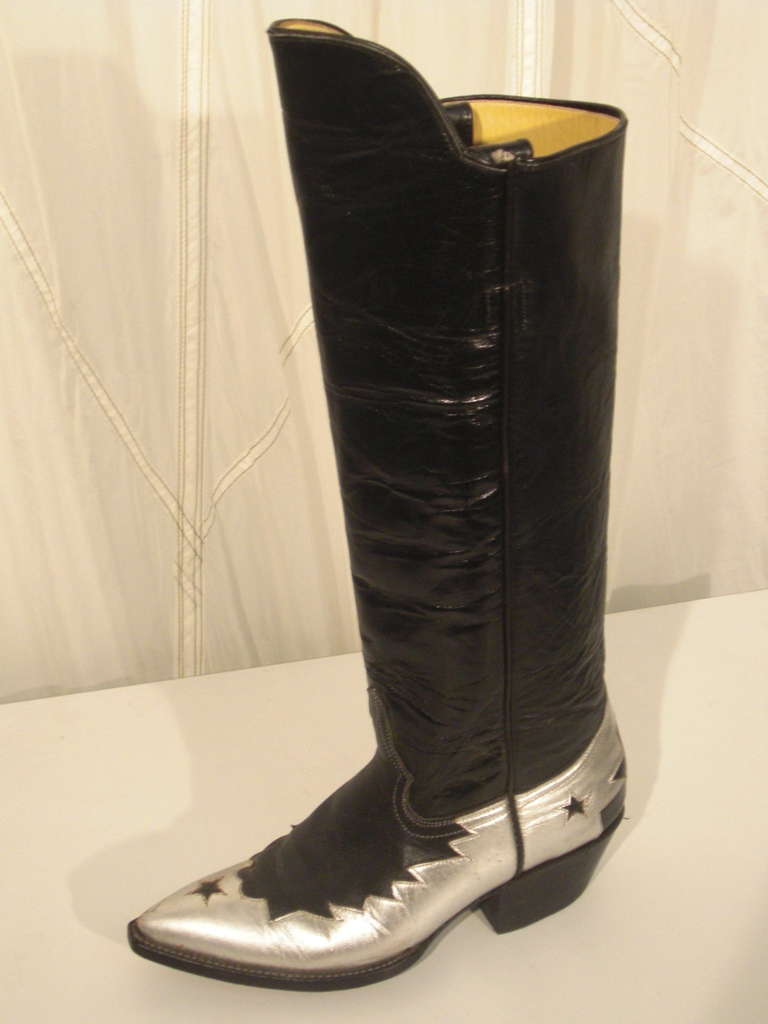 A gorgeous pair of leather western riding boots from SILVER with silver leather detailing.  Uppers rise higher in front of calf.  Pull-on loops inside top of boot.