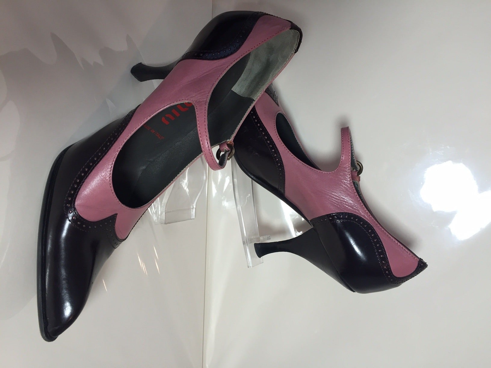 Fabulous Miu Miu pink and black leather Mary Jane buckle strap pumps in a spectator style with a peaked and pointed toe.