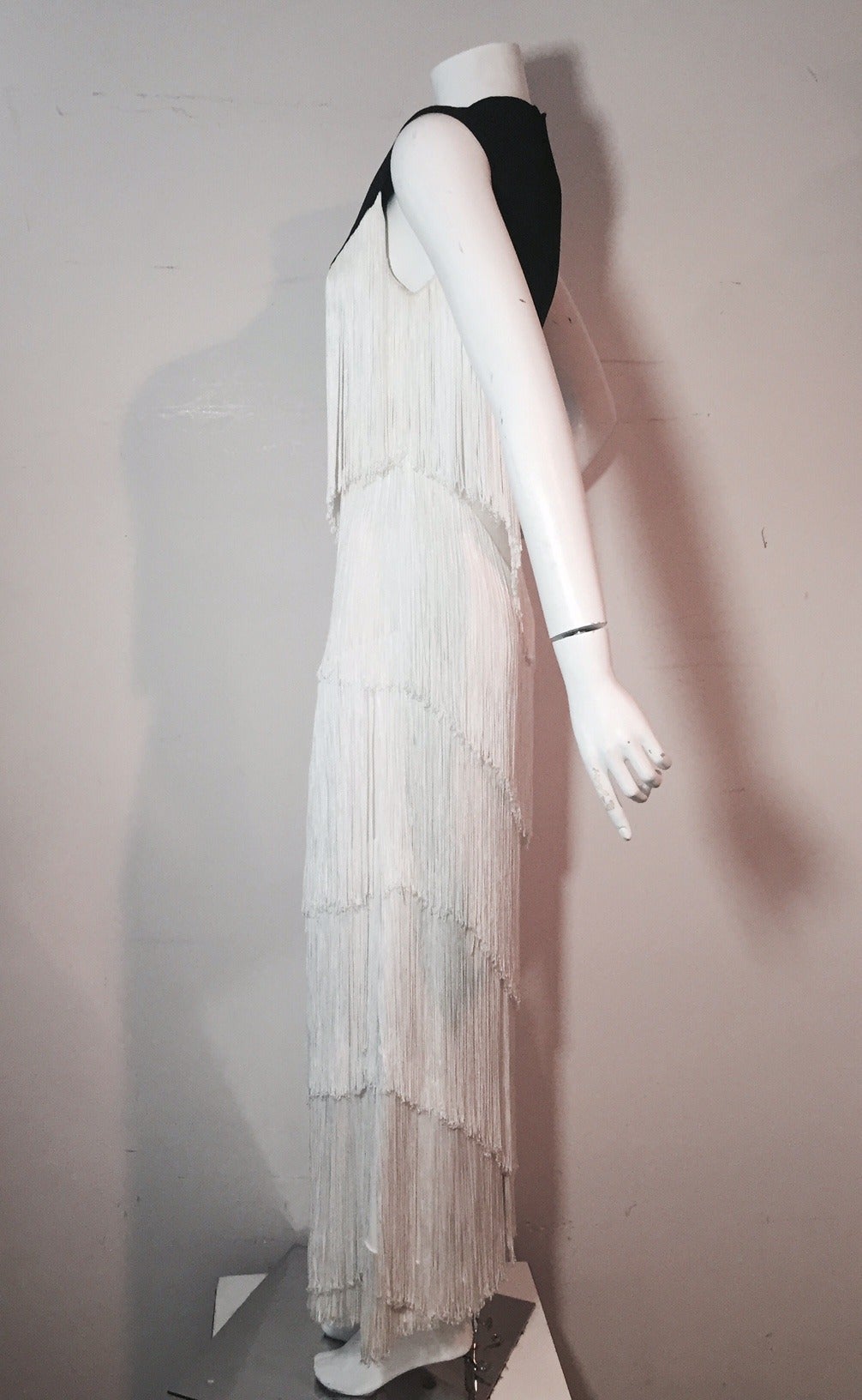 A fabulous fringed 1960s Elizabeth Arden black and white jersey sleeveless gown!  Rows and rows of fluid rayon fringe to move and shimmy!  Zippered back. Fully lined.