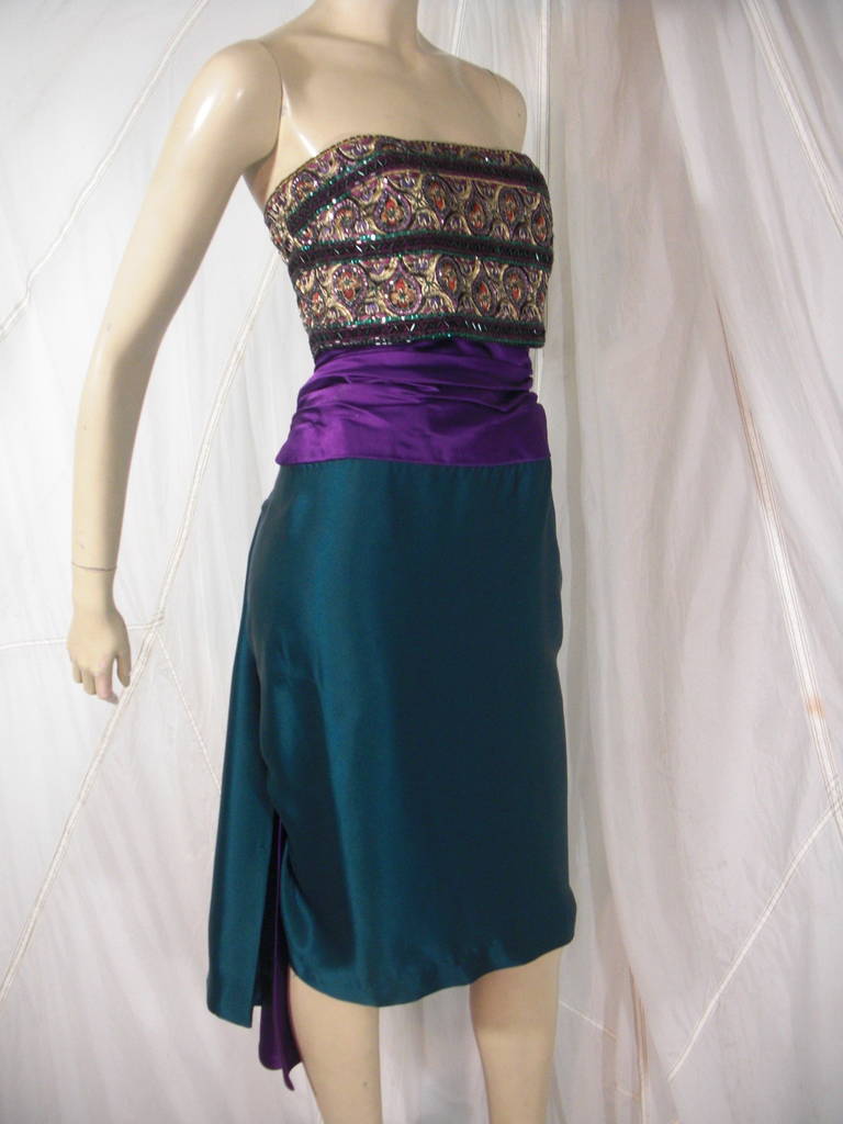 1980s Paul-Louis Orrier Teal and Purple Cocktail Dress with Gold Tudor Rose Pattern,  Bead, Sequin and Rhinestone Embellished Bodice
In Silk Satin with Gathered Fan Tail