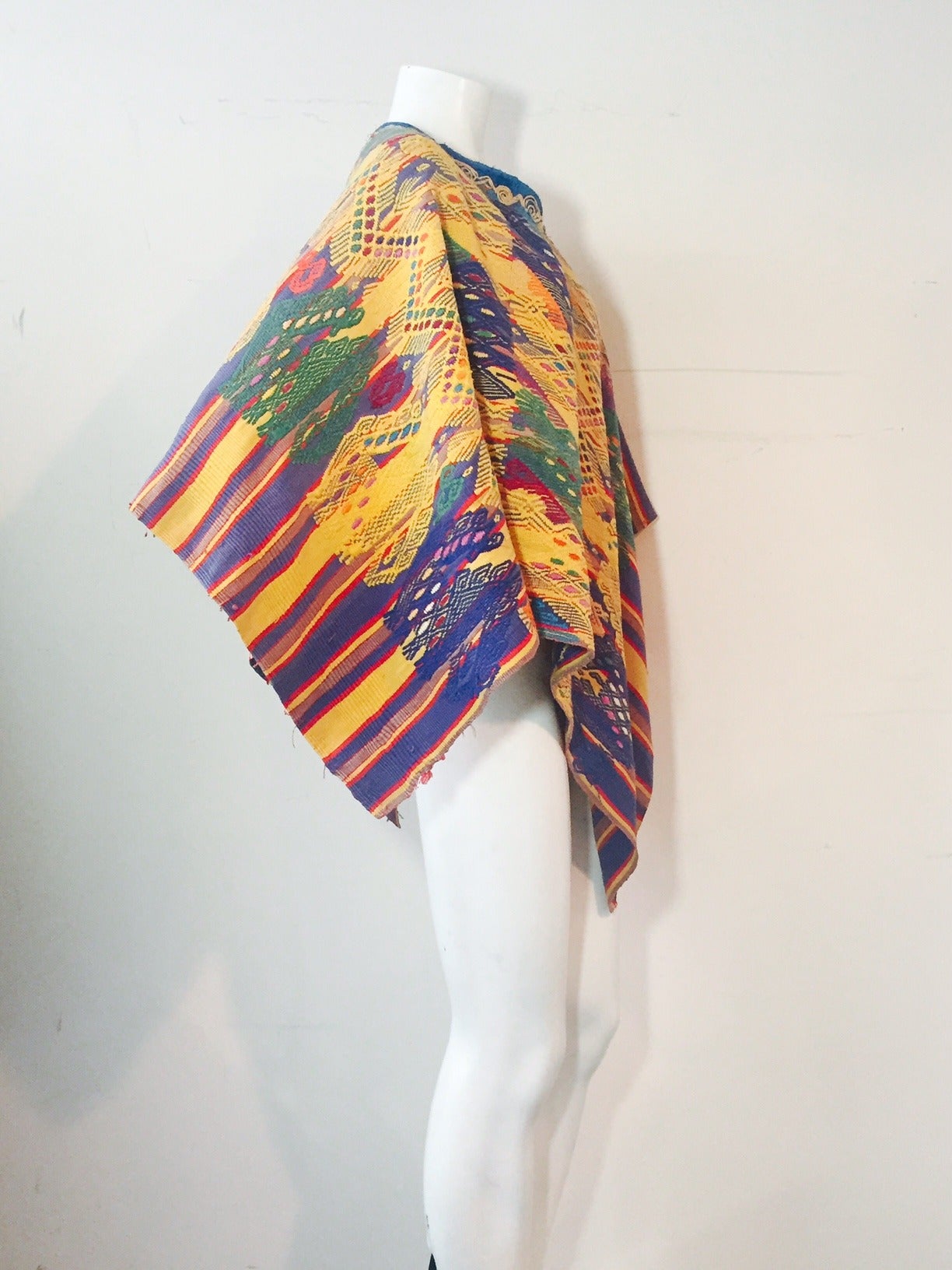 1960s traditional and colorful hand-woven cotton poncho from South America with velvet and embroidered neckline.