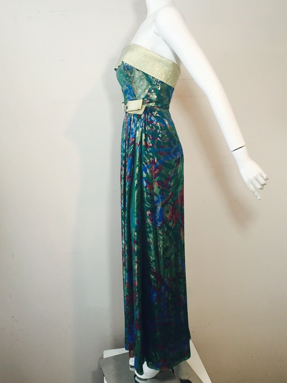 A gorgeous 1990s Hall Ludlow Australian Haute Couture Gown:  Blue, green and gold silk lame with fitted, banded strapless bodice and gathered full skirt.  Heavily stitched gold lame adds structure to the waist sash with bow and the banded top.  Back