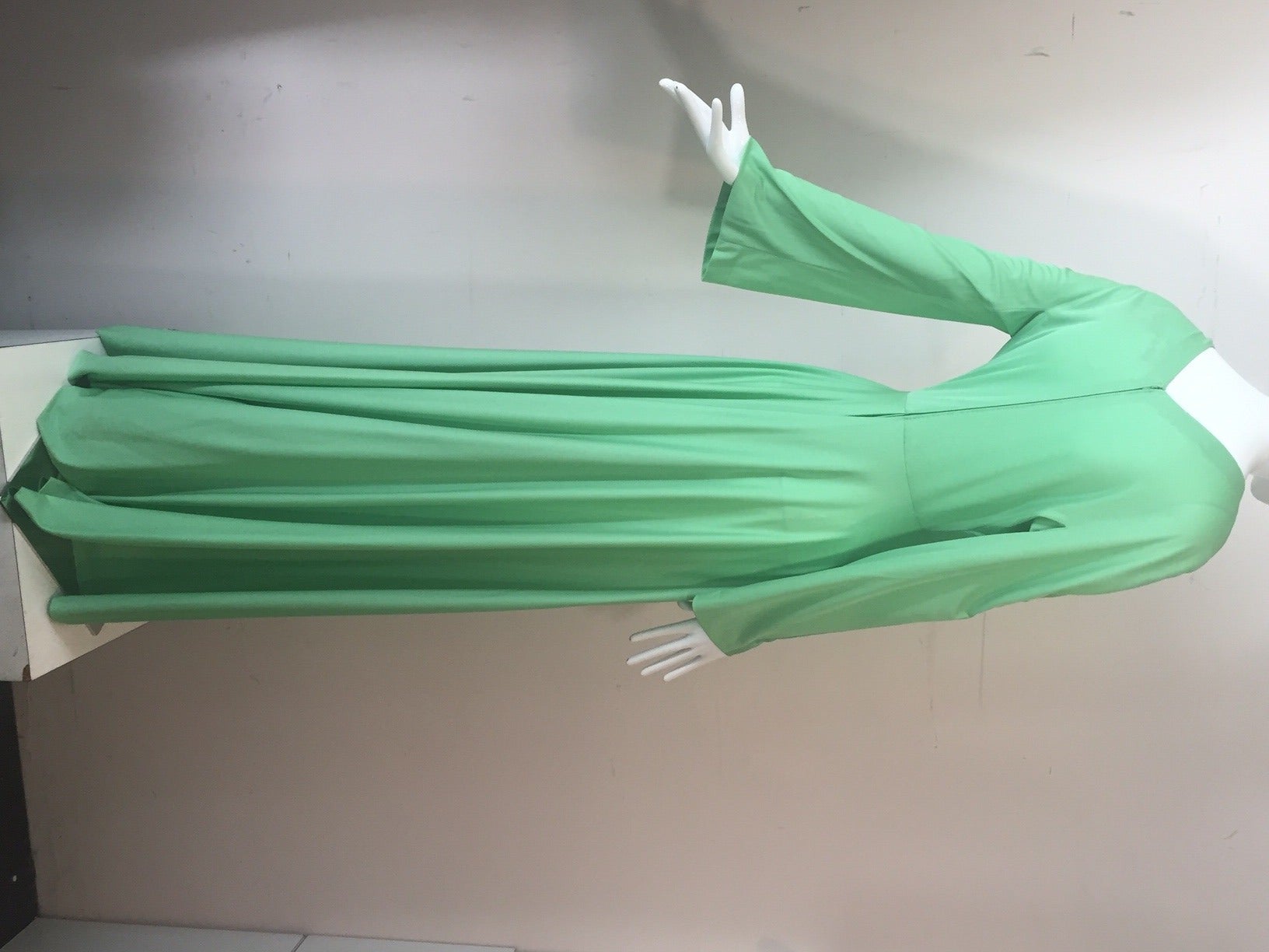 A fantastic and unusual 1960s Emilio Pucci pistachio green silk jersey jumpsuit: Bell sleeves and a deep plunging neckline. Back zipper closure.