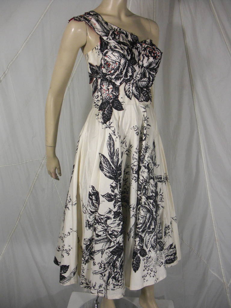 1950s White and Black Rose Print Asymmetrical Dress with applique Design and Red Half Bead Accents. With Boning
Made in Hawaii