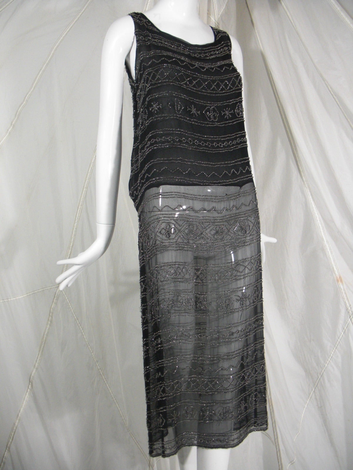 1920s Black Silk Flapper Dress with Elaborate Beading

Classic Dropped Waist Silhouette

Silk Chiffon