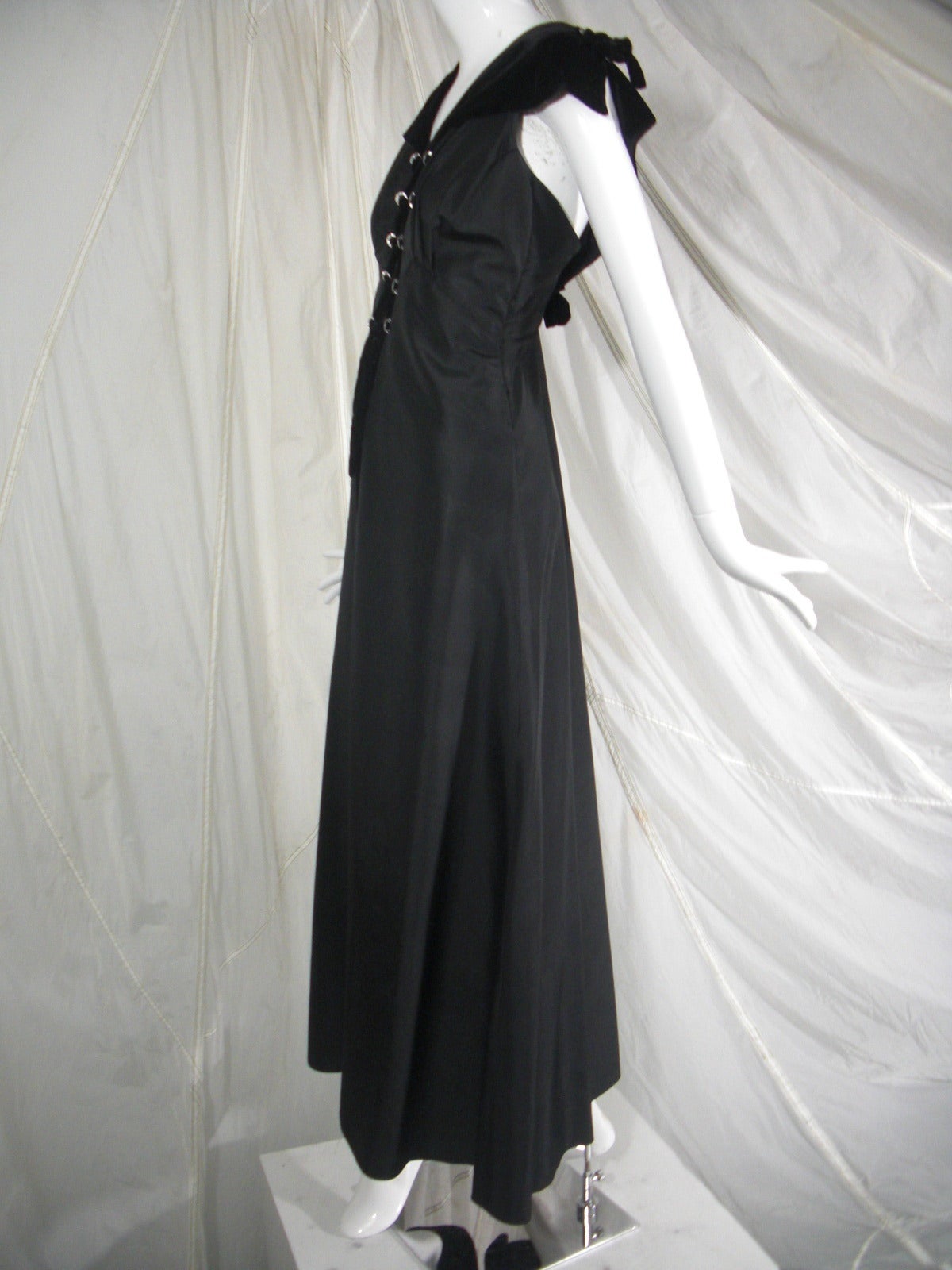 1930s Black Acetate and Velvet Lace Up Gown with Grommets

Period Style with Unusual Detail Back 

Lace Up Detail on Shoulder and Front 

Rhinestone Grommets