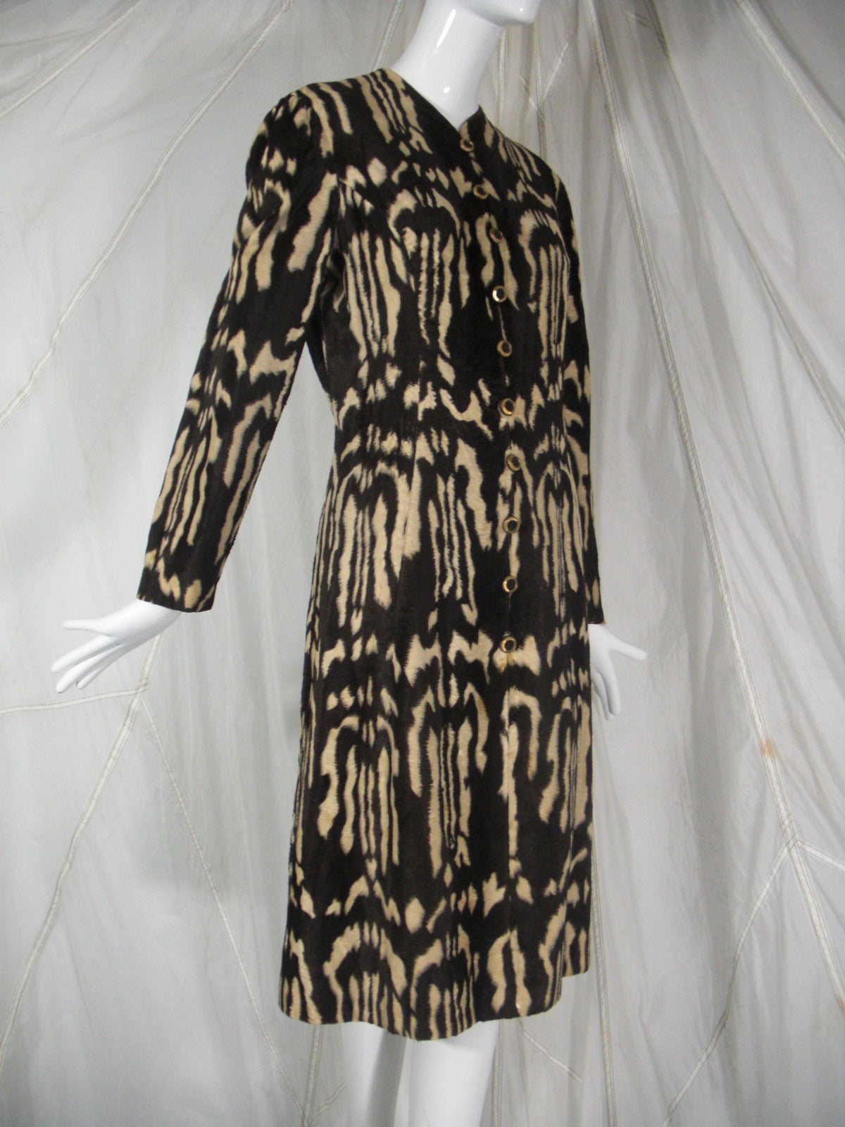 A fabulous 1960s Adele Simpson faux skunk fur button down dress with Nehru collar.  Fabric is akin to a long nap velvet, styled like fur.