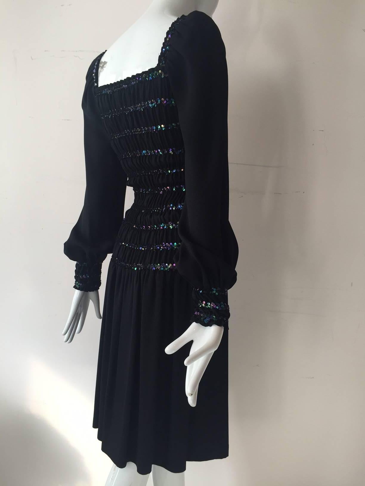 A bod-hugging 1970s Saint Laurent peasant-style dress:  Shirred elasticized body and cuffs, embellished with black iridescent sequins.  Balloon sleeves and full skirt in rayon satin-backed crepe. 