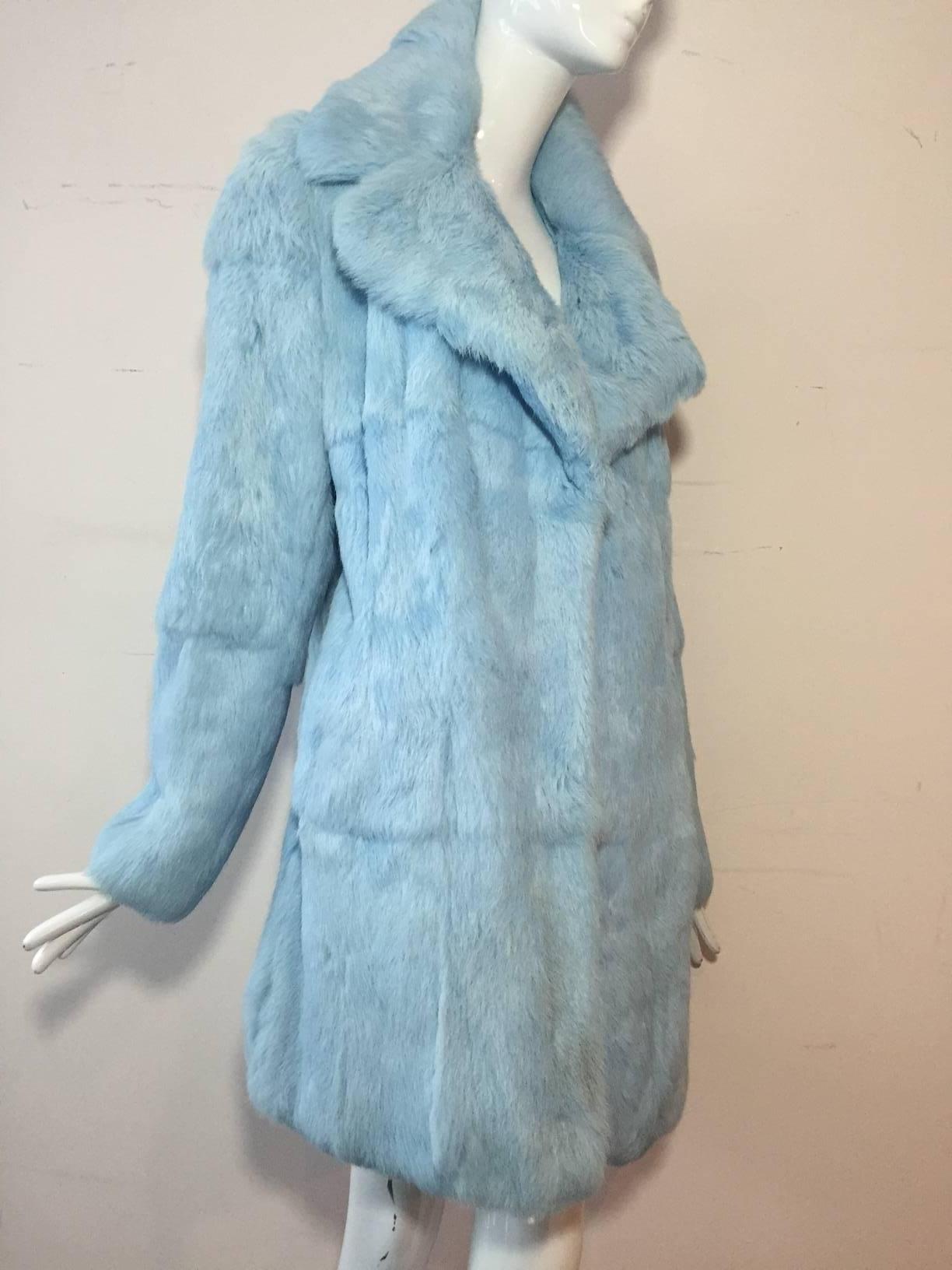 A fabulous Dolce & Gabbana runway featured baby blue rabbit fur jacket: wide notched collar and straight cut. Fully Lined. Inside tie closure. No outside closure. Which rock star wore it?  We can't say. 
