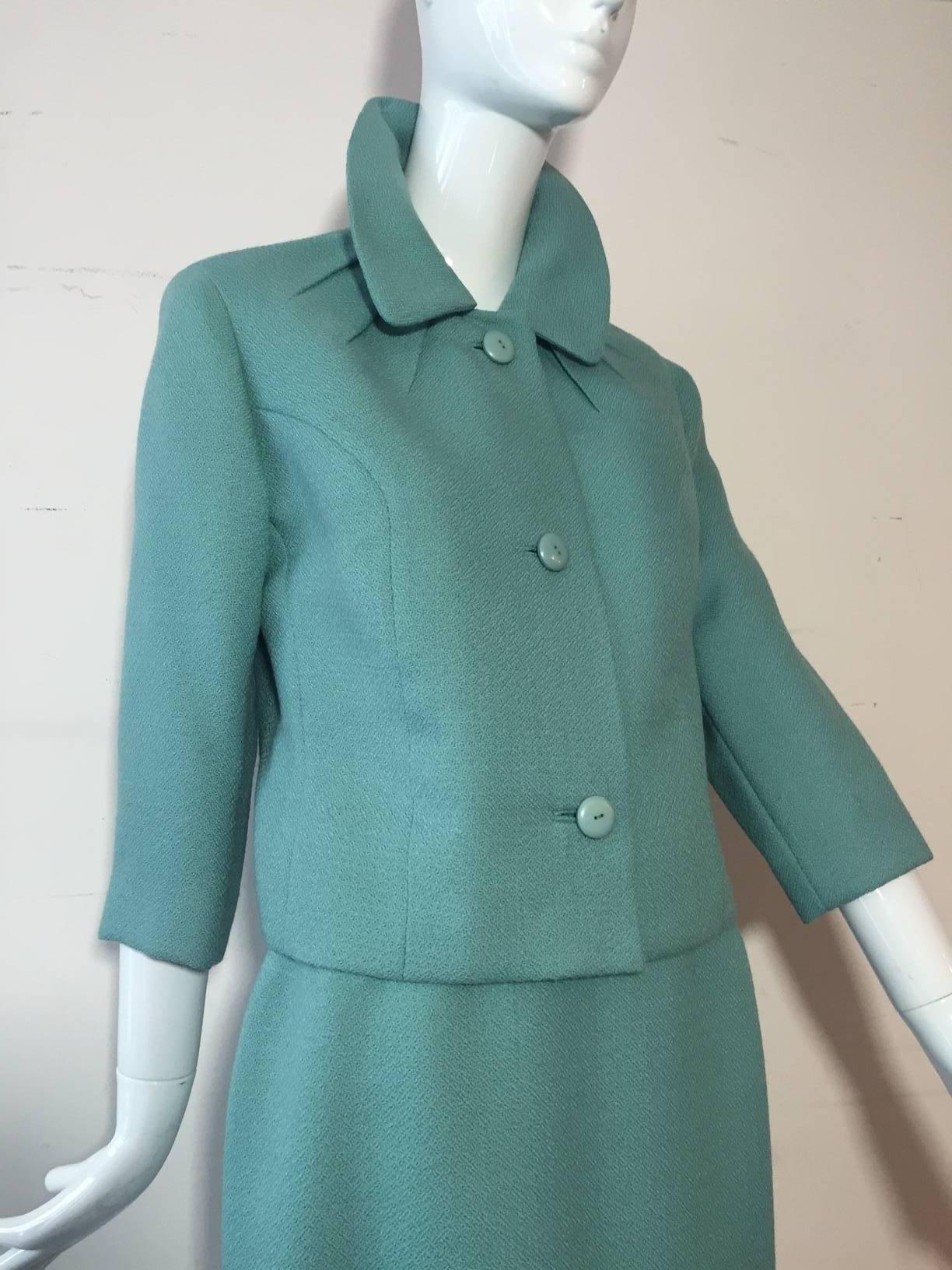 A gorgeous 1950s Jean Lanvin - Castillo turquoise wool skirt suit:  Completely lined in taupe satin. A straight skirt and boxy cut jacket with button closures, princess seaming and featured darting detail at neckline. Originally sold at I. Magnin. 