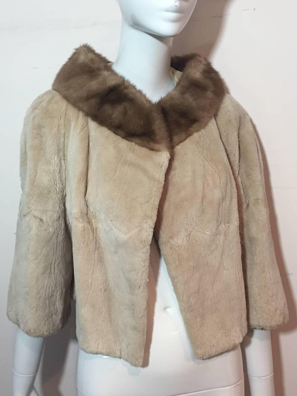 A beautiful 1950s fawn color sheared beaver fur coat: cropped with 3/4 length sleeves.  Completely lined. Single closure at top.  Mink collar.  Matching mink hat included. 