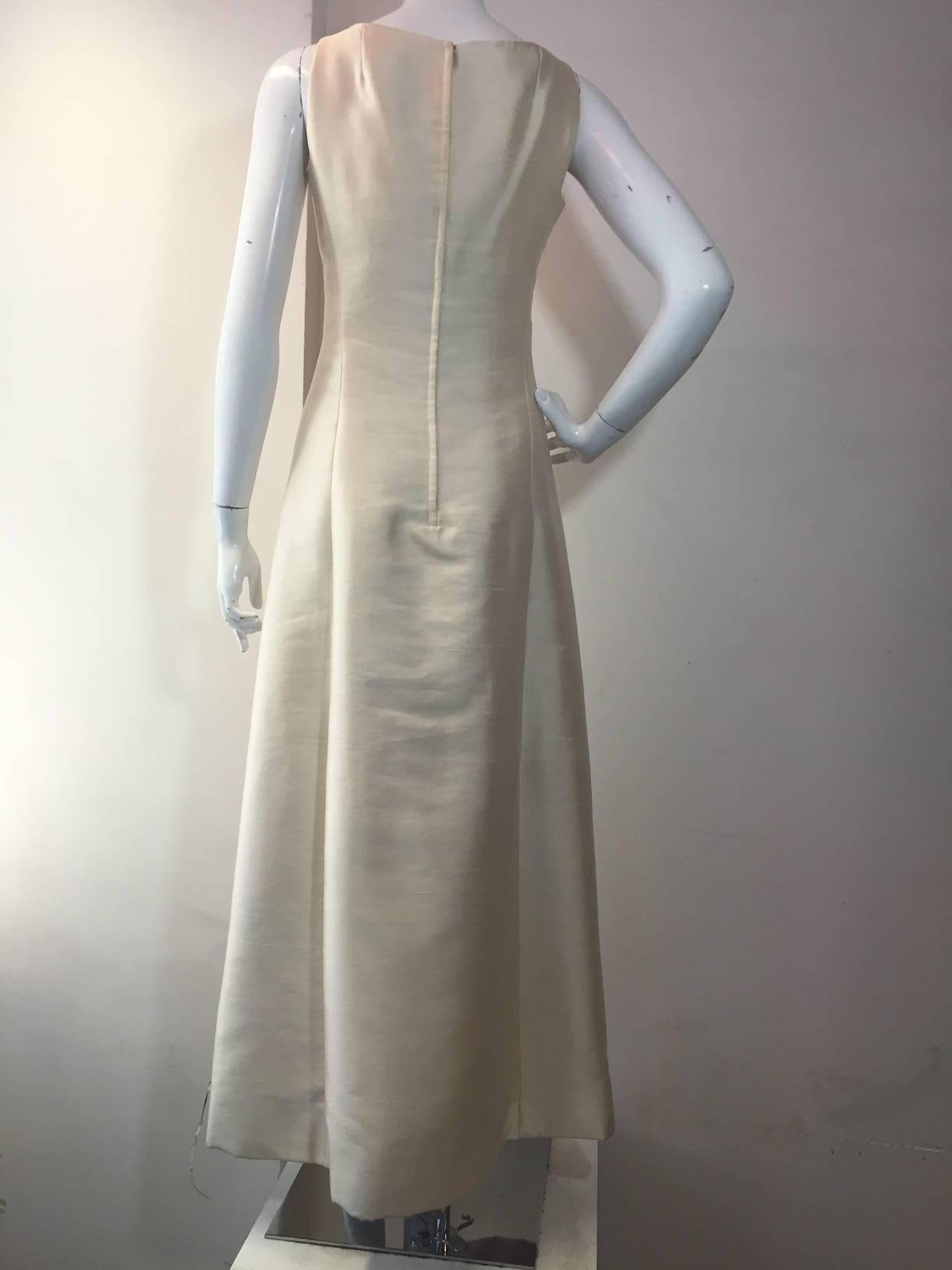 A stunningly simple appearing, yet masterfully designed 1960s Bob Bugnand ivory silk shantung evening gown:  princess seaming, sleeveless. Skirt is interfaced for form.