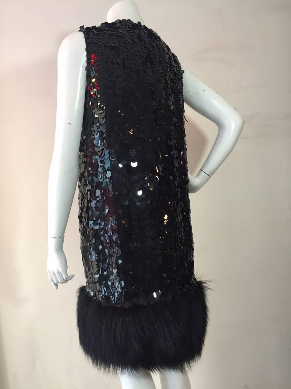 A fabulous Norman Ambrose silk shift dress perfect for cocktails!  Covered completely in black sequins and paillettes, fully lined with a wide fox fur trim at hem.  