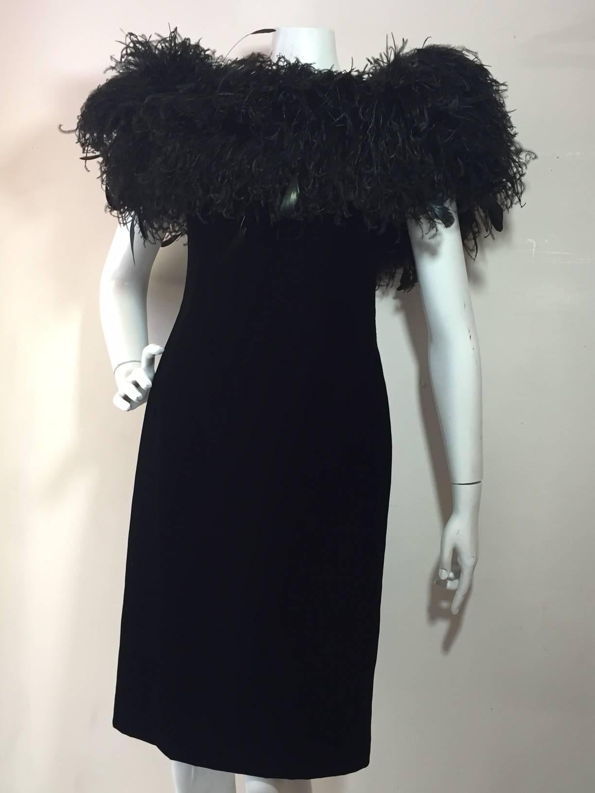 A fabulous and extravagant 1980s Victor Costa black velvet strapless cocktail sheath with off-the-shoulder sleeves, boned bodice and massive ostrich feather neckline. 