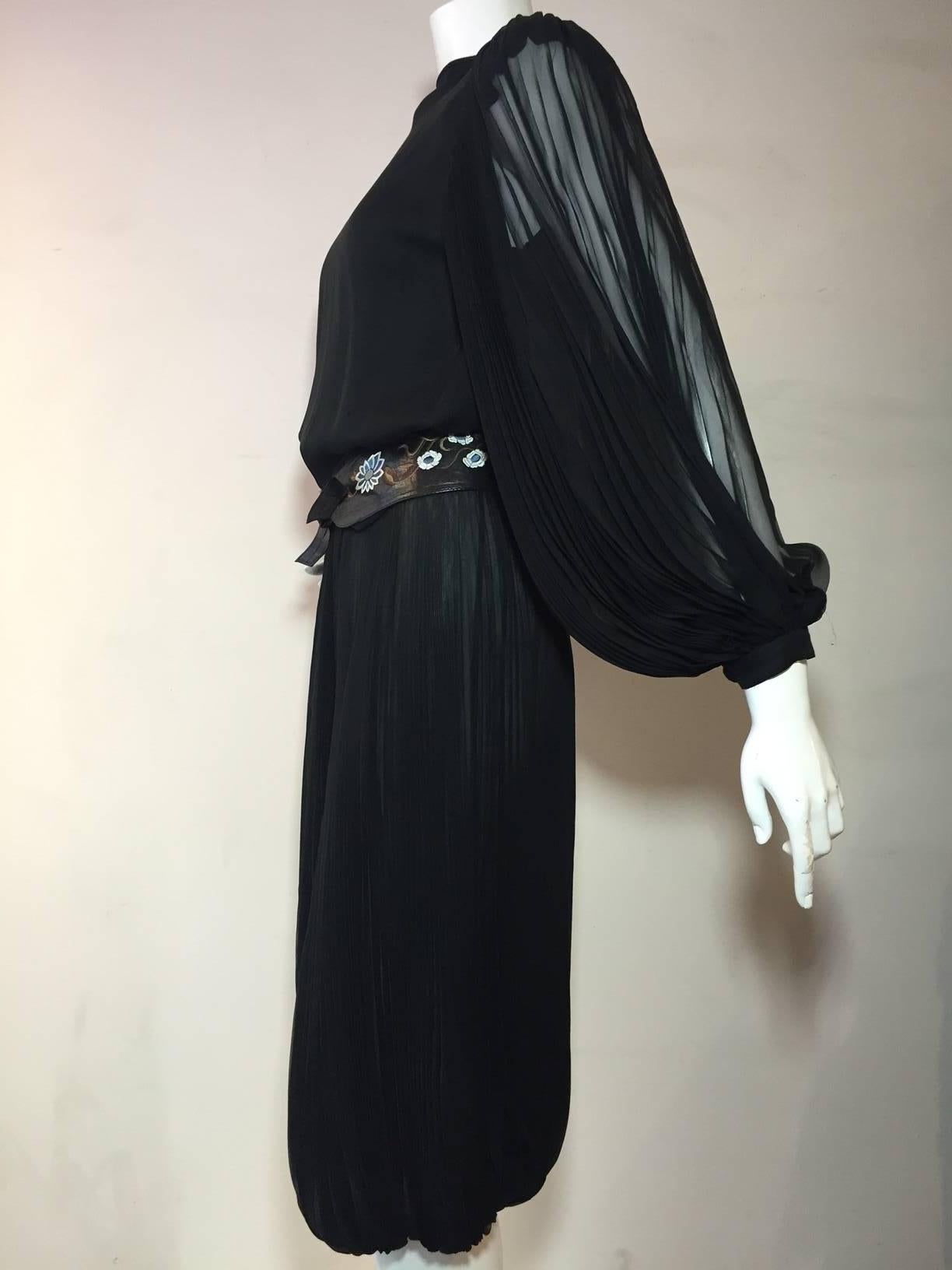 A fabulous 1970s James Galanos gaucho jumpsuit:  Black silk chiffon heavily pleated and elasticized at the calf.  Buttons down the back. Includes tooled leather tie belt (not original).