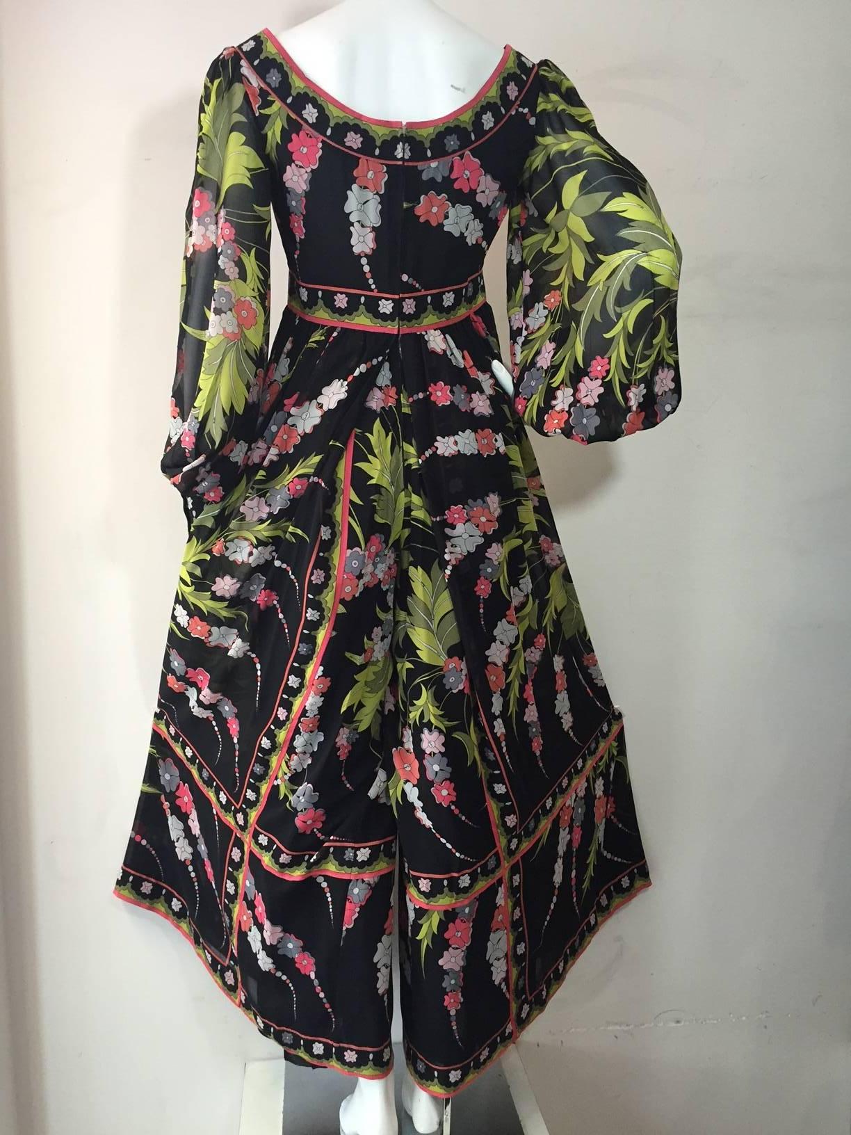 A fabulous 1970s Emilio Pucci jumpsuit:  black background floral printed silk chiffon in lime, pink and slate, fitted band waist and ballet neckline full, voluminous legs.   Cuffed balloon sleeves. 