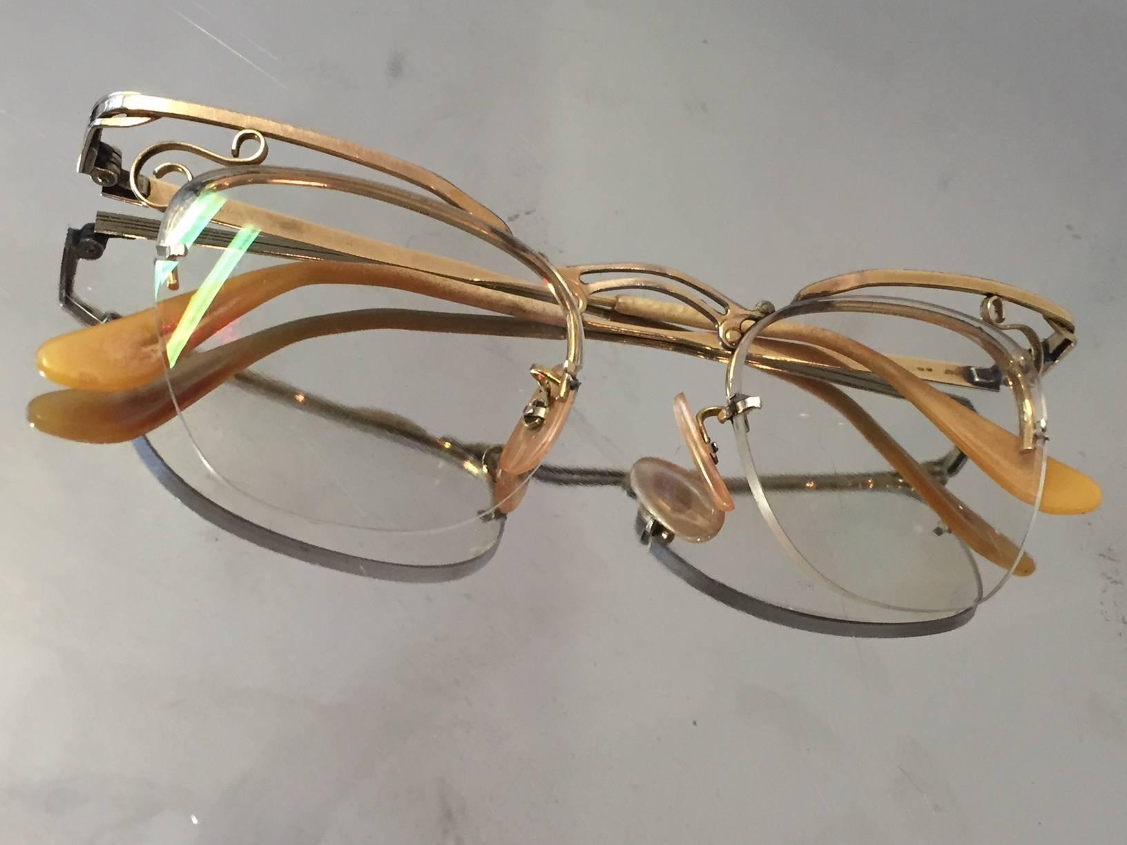 A gorgeous 1950s delicate pair of gold-filled cat-eye eyeglass frames. Open scroll-work at temples. Marked B&L 1/10 12KT GF.  Size 5 1/4