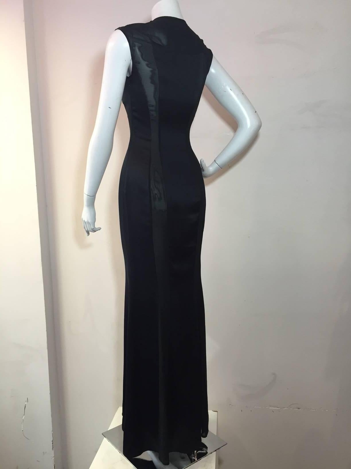 A 1990s  Richard Tyler silk satin gown in black with daring sheer silk and lycra chiffon panels running the length of the gown giving it a body conscious fit.  Flared fishtail hem.  Snap closures at shoulder.