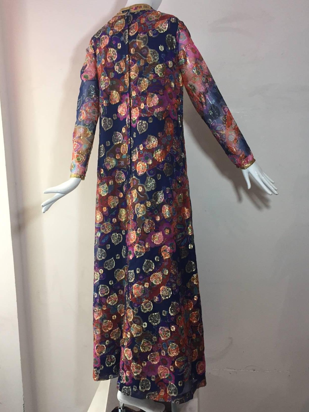 A fabulous sheer sleeved 1960s Saks Fifth Avenue kaleidoscopic lame hostess gown:  Banded collar, Fully lined, back zip. Side pockets. 