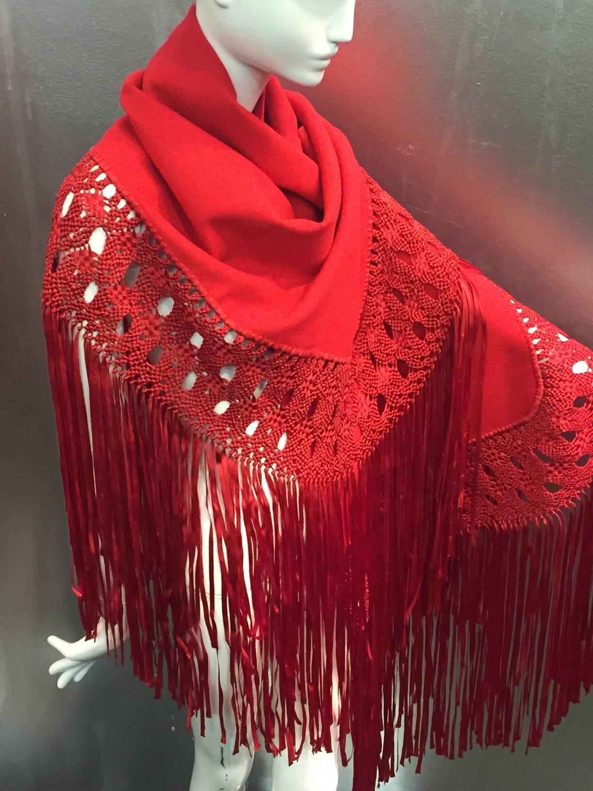 A stunning 1970s cardinal red wool crepe and macrame ribbon fringed shawl.  Trimmed in beautiful macrame fringe on three sides. 

Wool crepe part measures 56