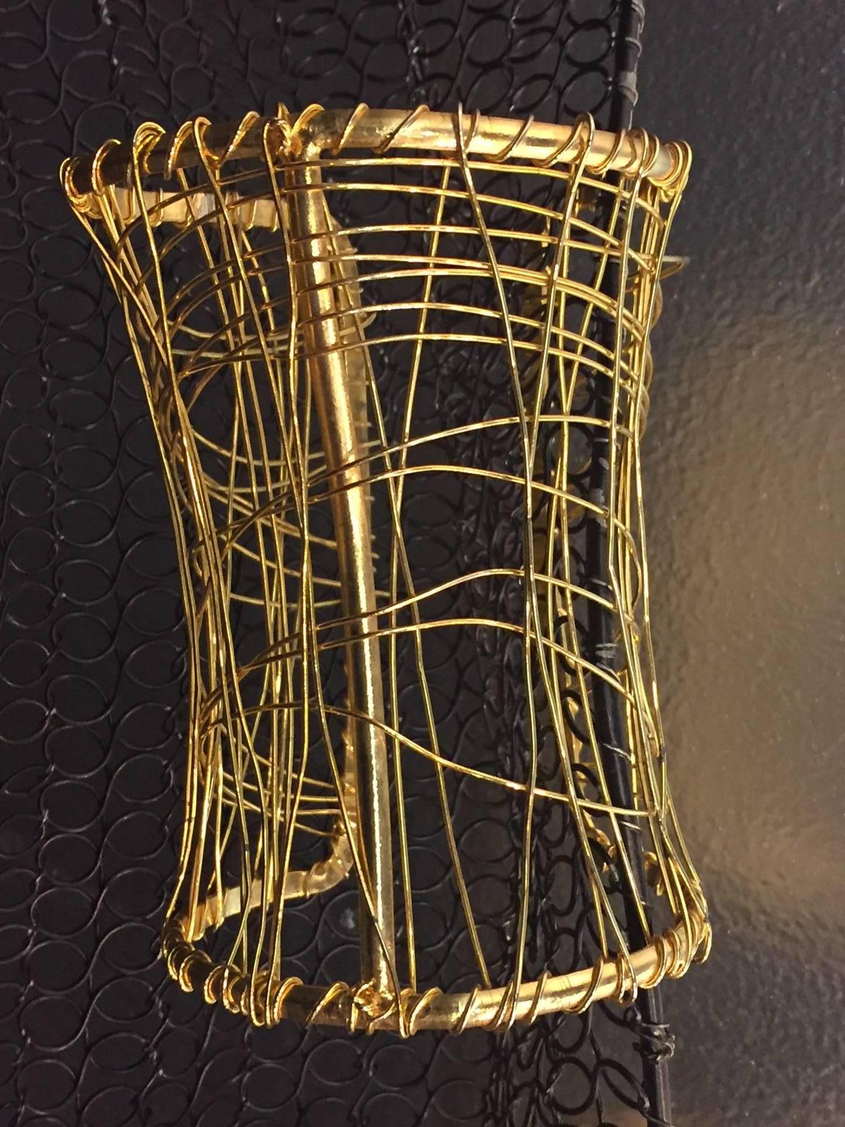 One pair of 1980s wire cage cuffs:  4