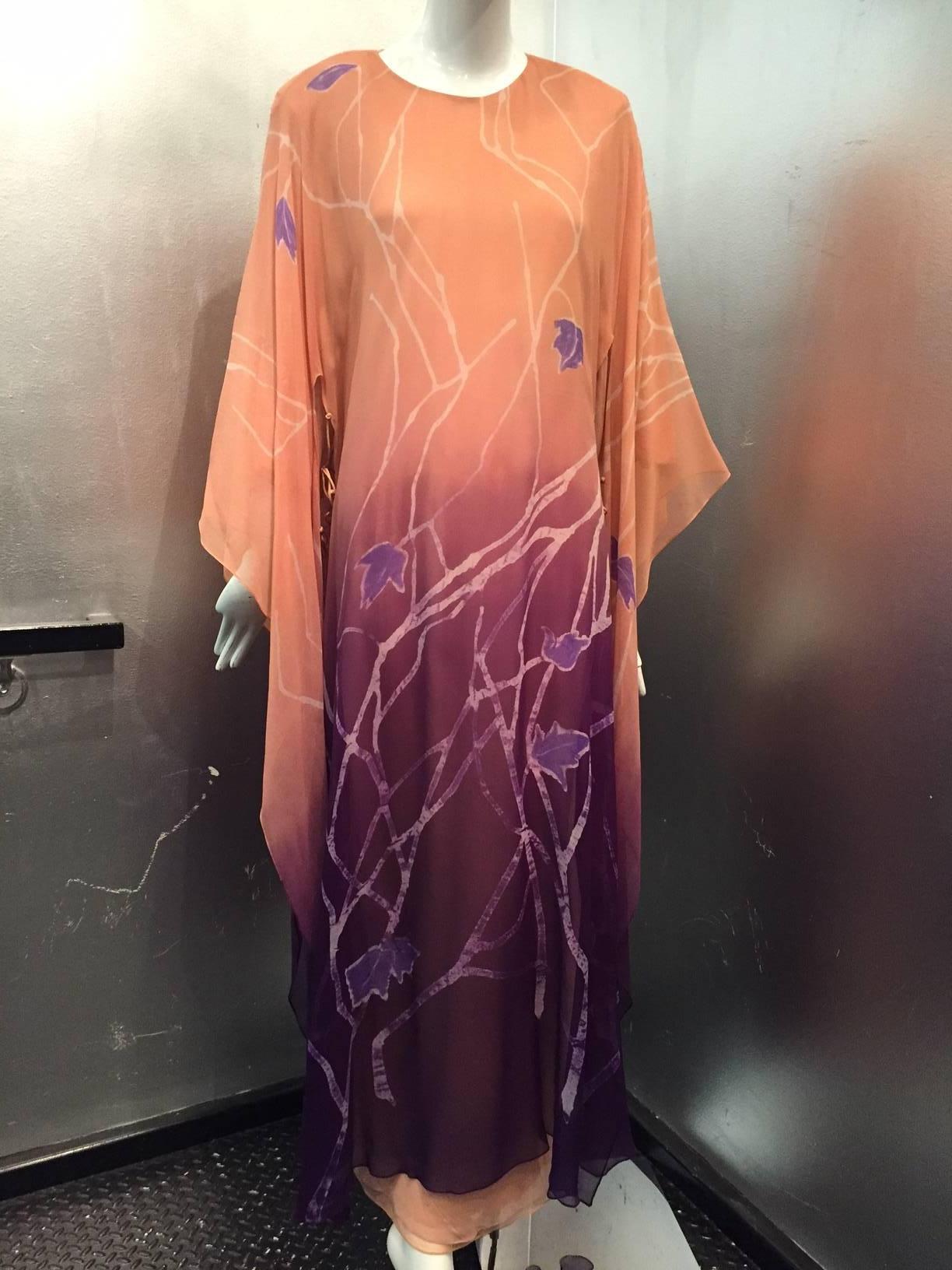 1970s Iris Feragaroa hand-painted silk chiffon caftan in peach and purple:  Branch and leaf motifs adorn this kimono-inspired caftan.  Three layers of silk chiffon and crepe linings.  Overlay is ombre with open sides and sleeves that tie together.  