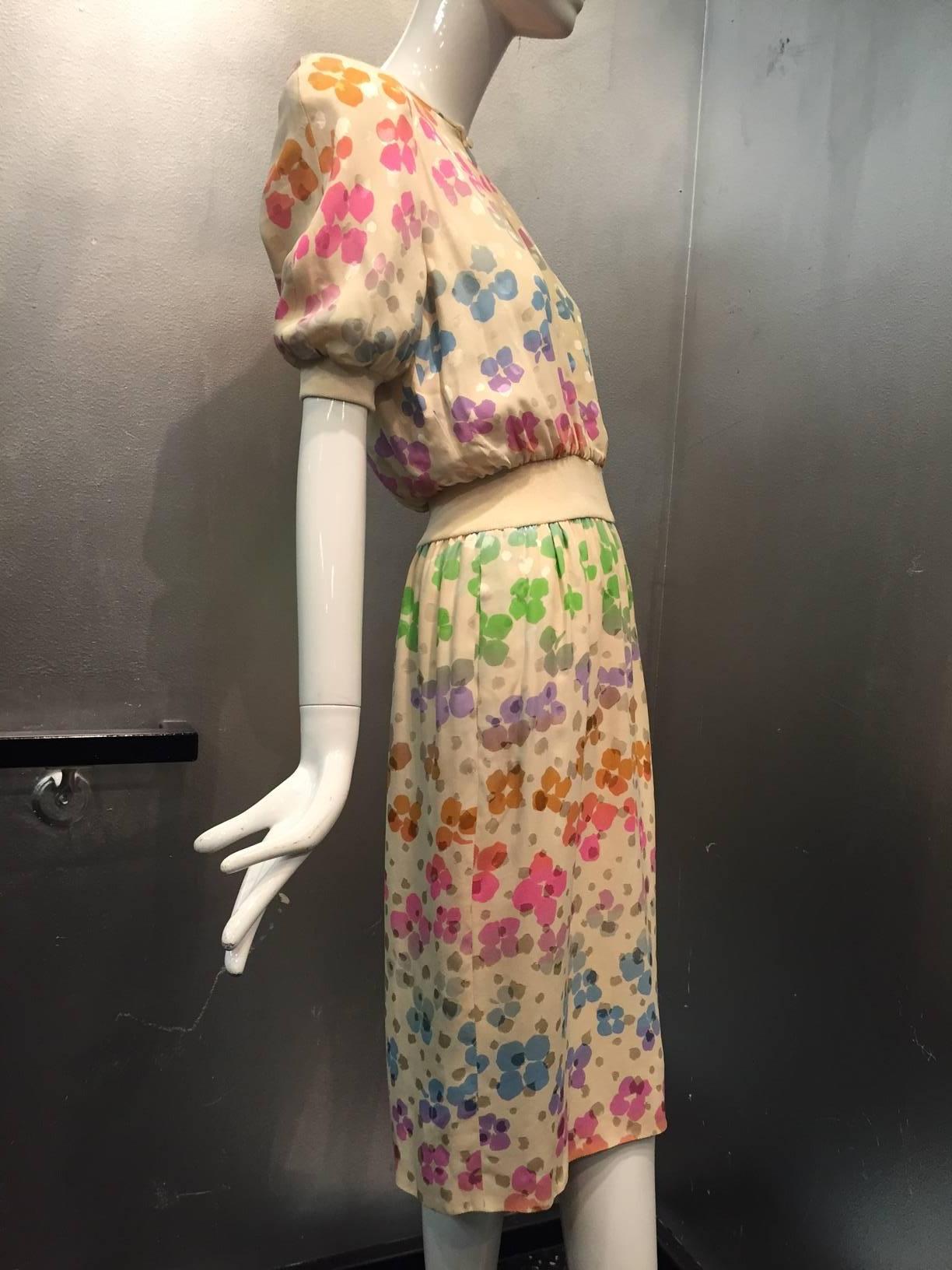 A beautiful Valentino silk jacquard dress with rainbow florals:  Keyhole neck closure, Fitted rib knit waistband, blouson waist, raglan sleeves, padded shoulder.  Completely lined with side slash pockets. 