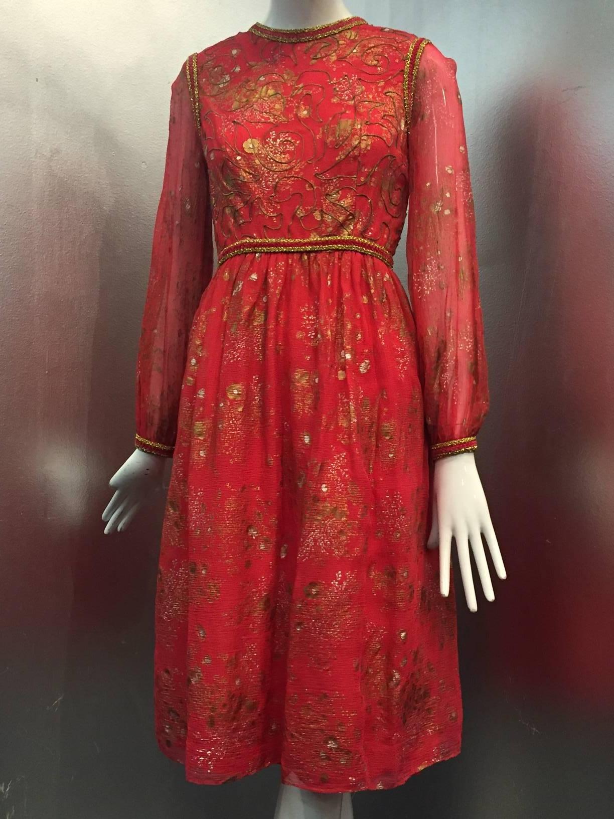 An early 1970s Oscar de La Renta red silk plisse peasant-inspired dress:  Plisse silk is stamped throughout with gold and silver floral sprays.  bodice is edged in gold and red chenille braid and covered in couch buillion cording. 