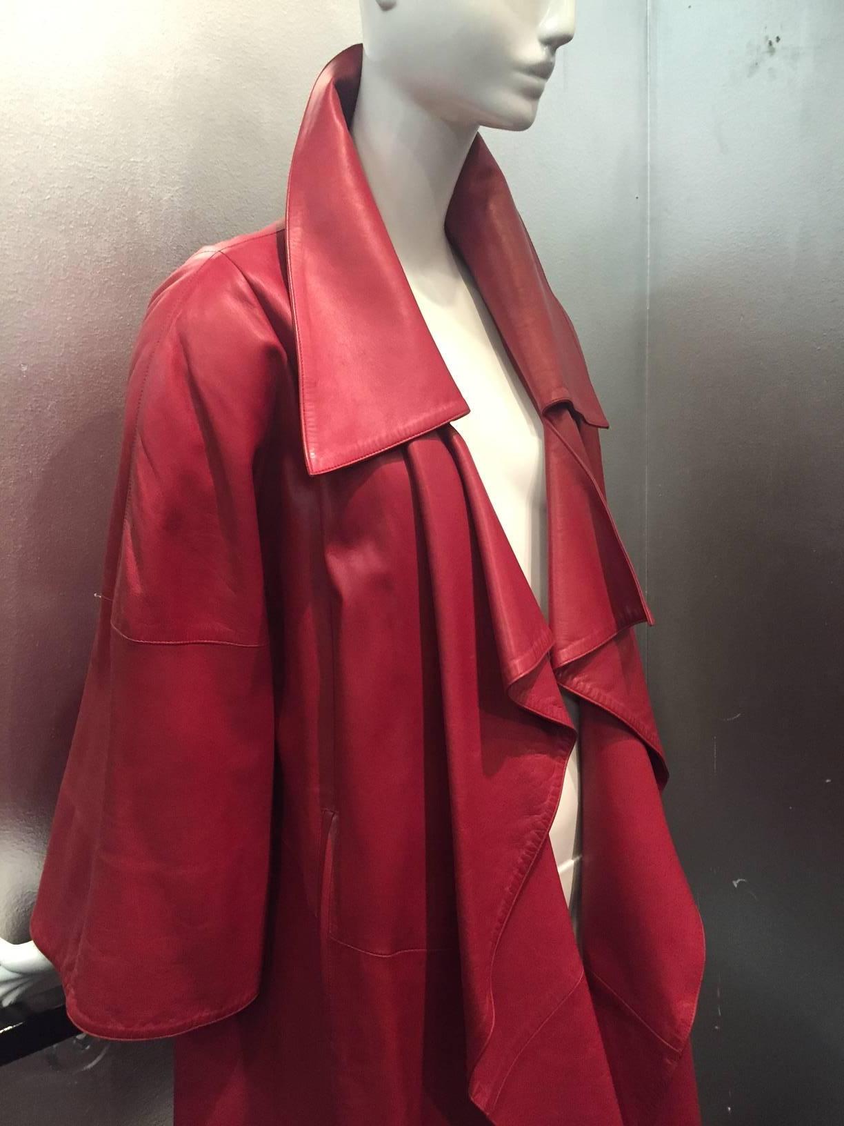 A fabulous, supple 1980s Claude Montana red leather trench coat with draped collar.  Acetate lining. No closures. 
