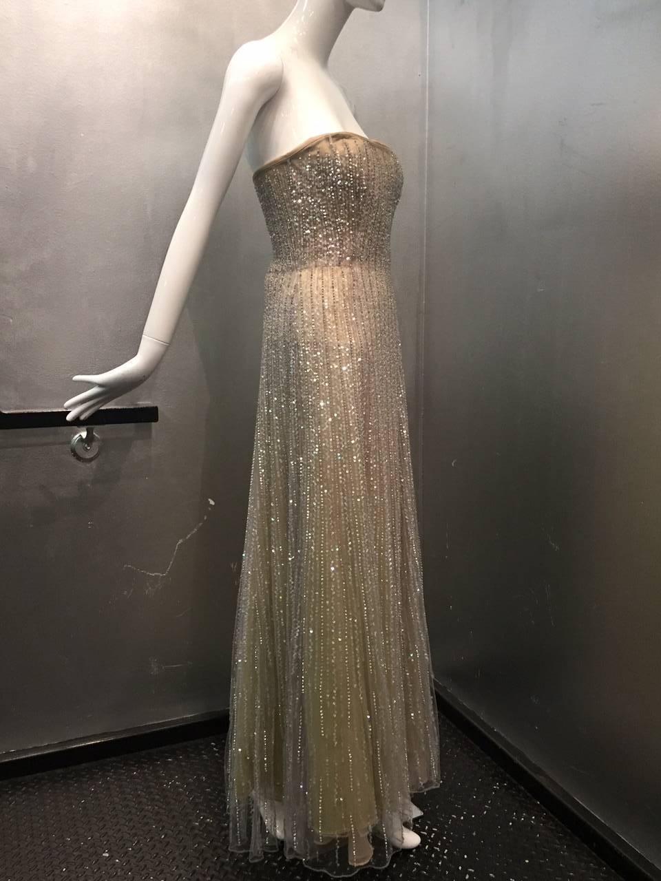 Oscar de La Renta etherial silver tulle gown: Strapless with boned and structured bodice, zippered back.  5-Layer underpinnings in taupe, citrine and silver.  Tulle is sequined and beaded with lame threads.  Unlabeled, by confirmed to have been