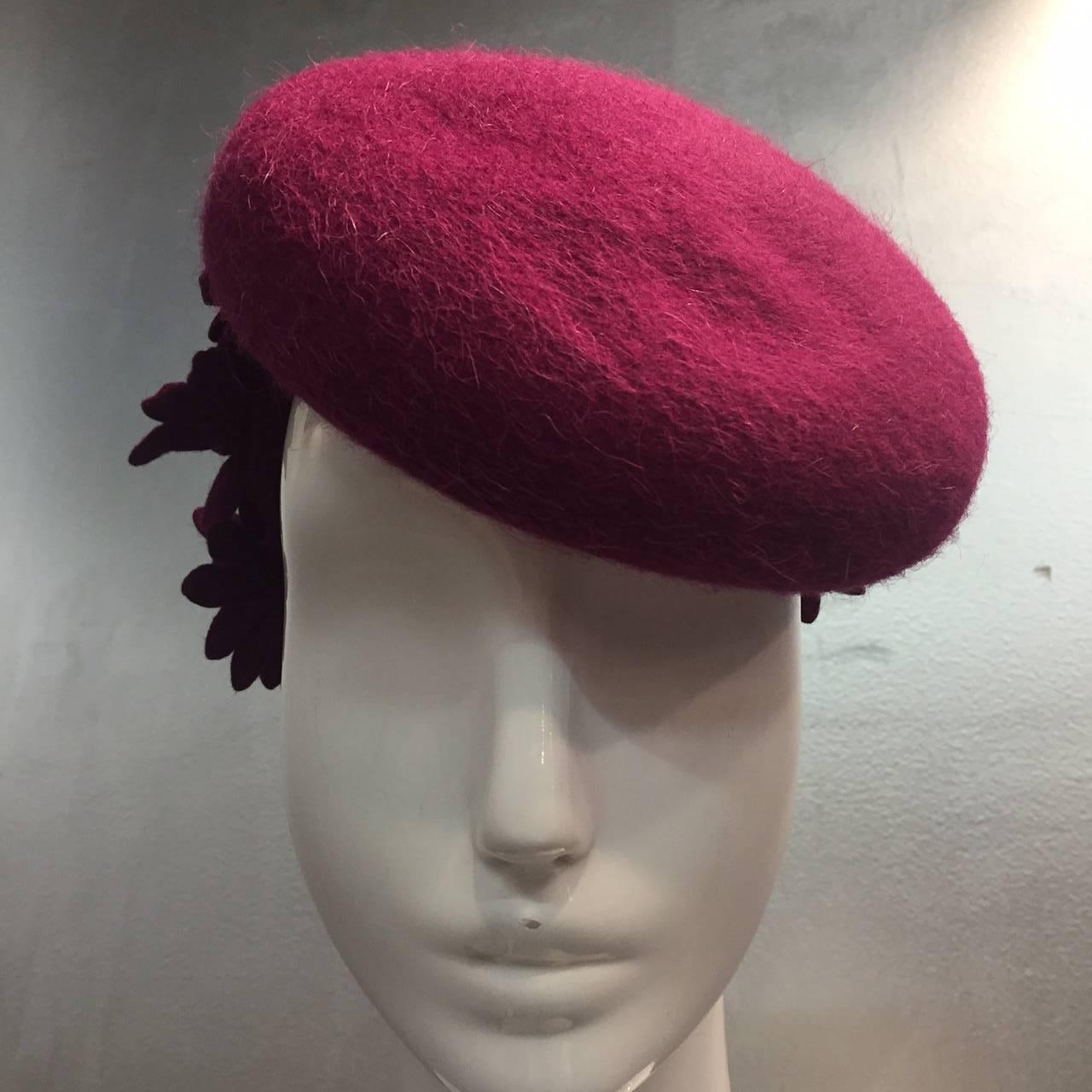 A beautiful 1940s Valerie Modes magenta felt tilt hat with ring band embellished in back with felt flowers.  New York Creations Guild tag. One Size Fits all. 