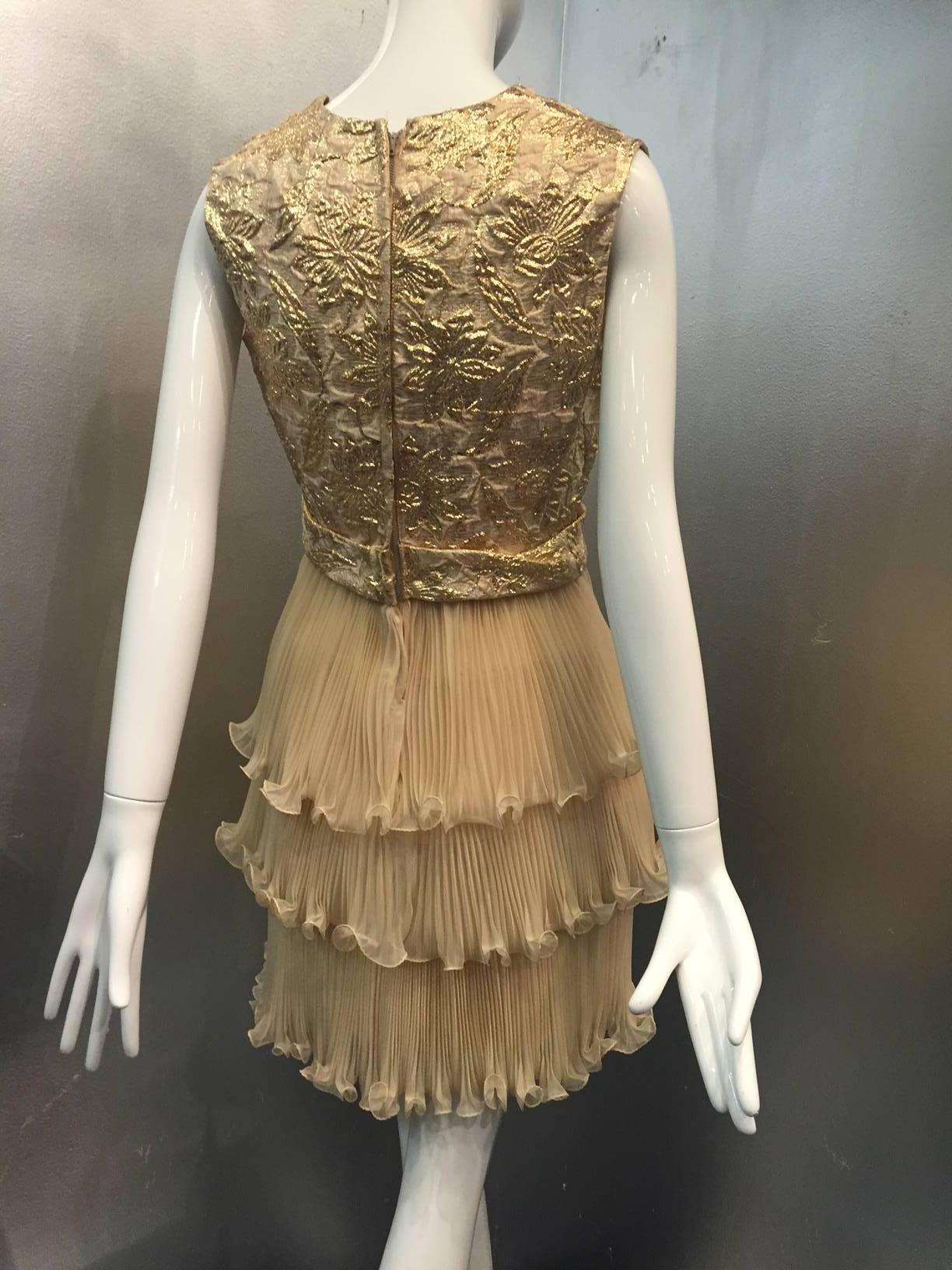 A beautiful 1960s lame and pleated organza cocktail dress:  bodice and belt are gold lame brocade with a center bow on the belt.  Skirt is three-tiered micro-pleated organza with ruffled edging. Completely lined. 