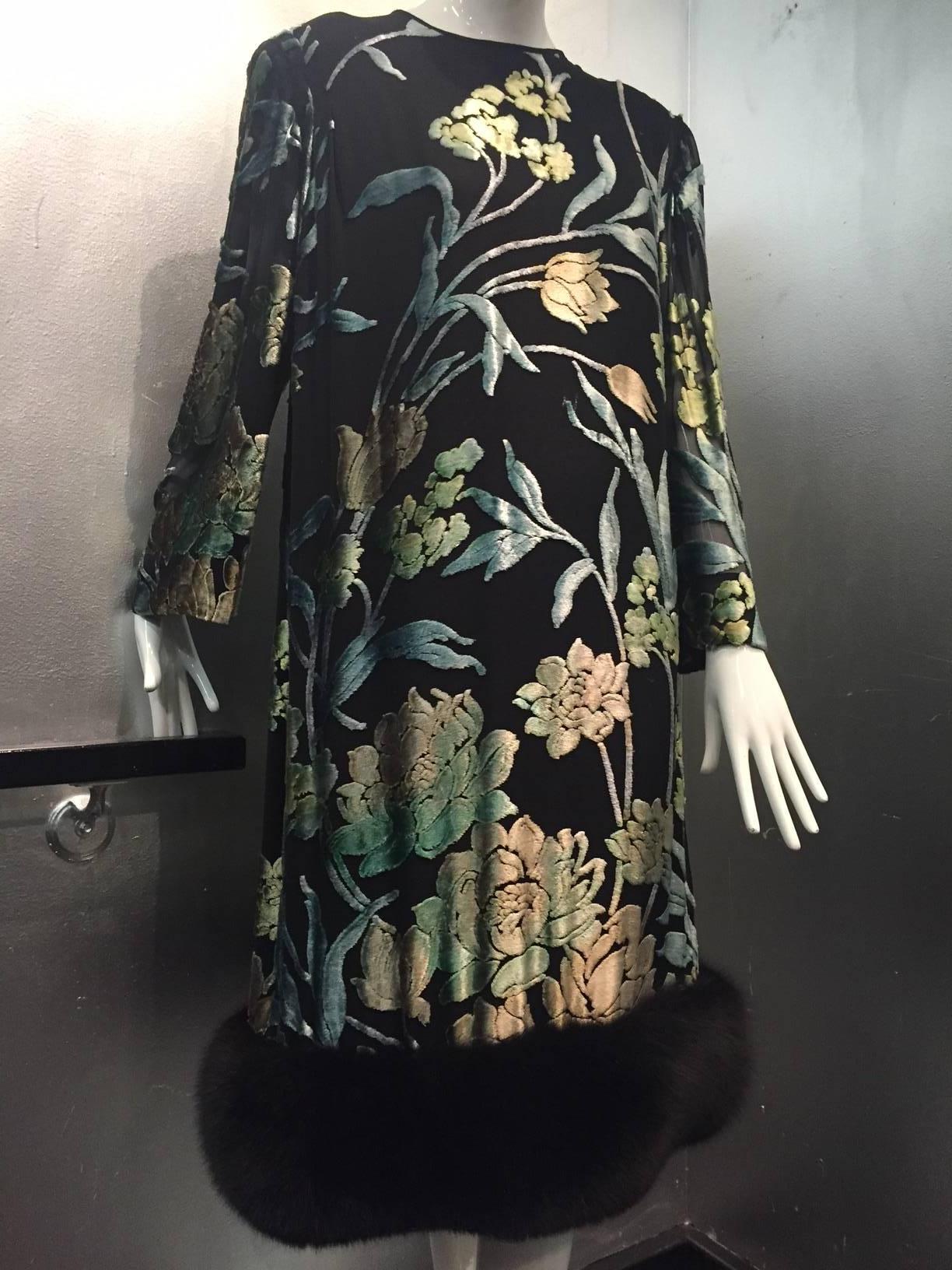 A gorgeous 1980s Pauline Trigere silk devore velvet cocktail dress with black ground and pastel florals.  Zipper back, shoulder pads and black fox fur hem.  Fully lined with a relaxed draped fit. 