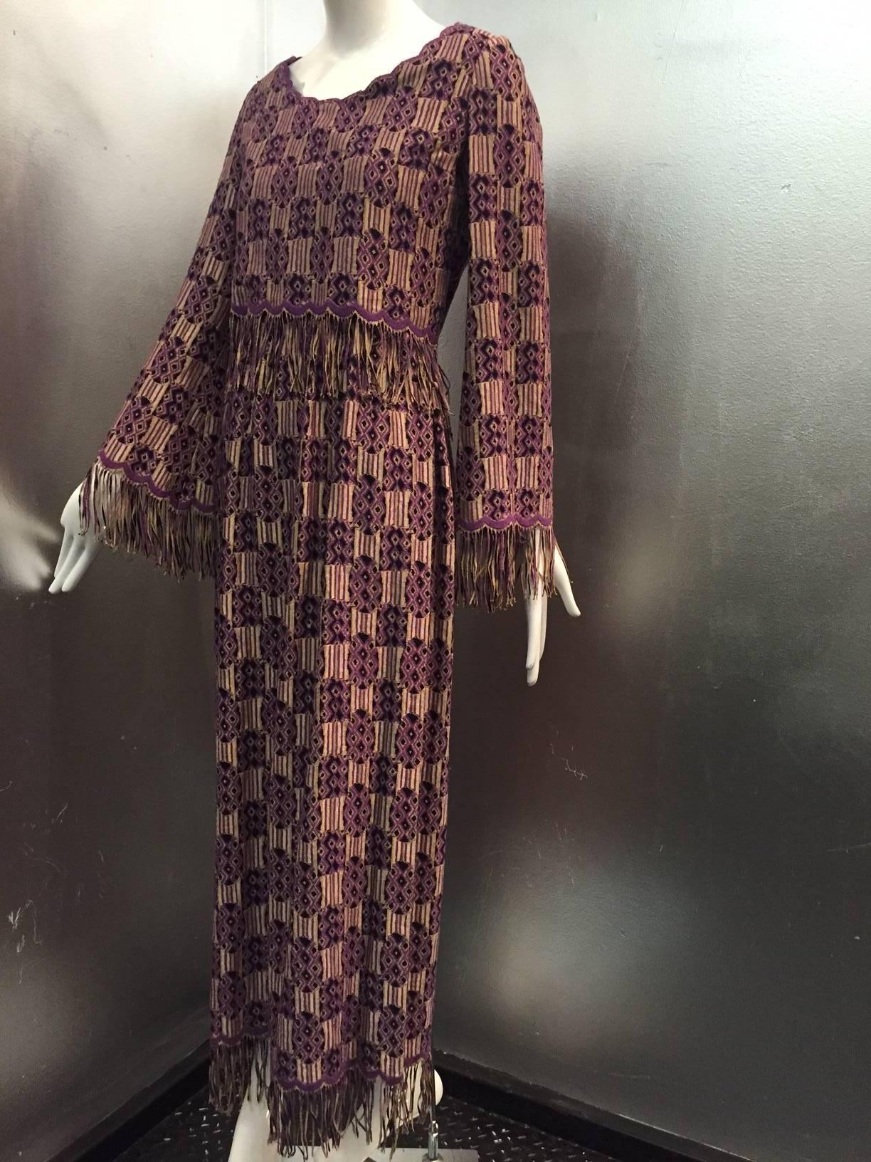 A wonderful late 1960s Christian Dior ethnic-inspired purple, black and tan brocade maxi dress with free floating top overlay. Scalloped and fringed sleeves, midriff and hem. Zippered back.