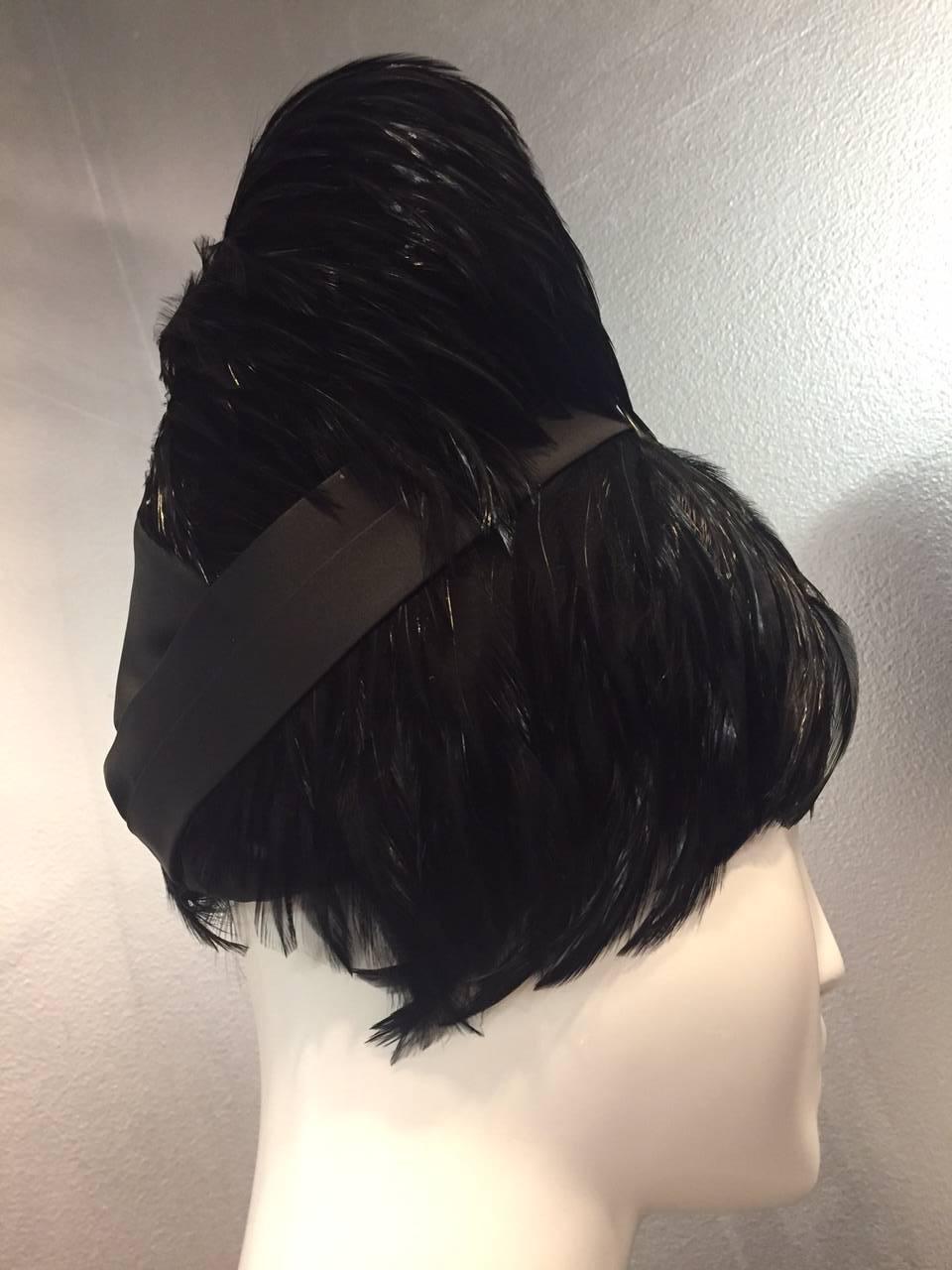 A fabulous 1960s Sonni of California black rooster feather, beehive styled wig hat, with a wide satin band at top. 