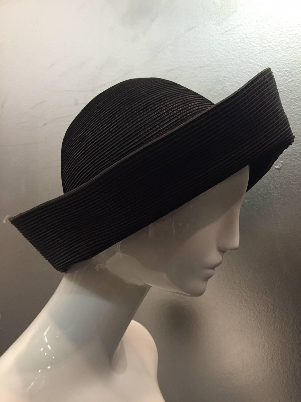 A stylish and versatile 1980s Patricia Underwood corded and sewn as millenary straw would be in a wide brim hat that can be worn with brim up or down or pinned at one side.