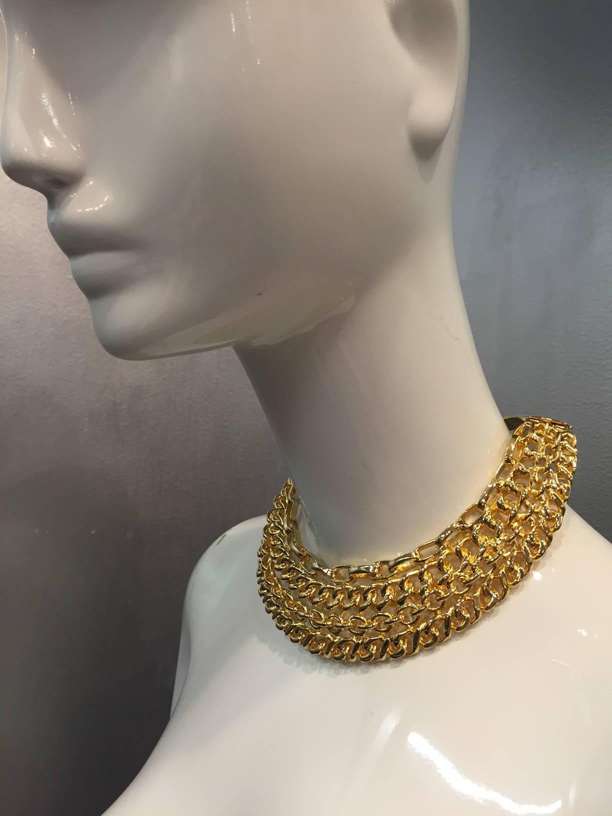 1980s Kenneth Jay Lane gold-tone 4-strand chain-link collar:  This piece is a solid collar plate, all links are fixed in place with hinged panels at back.  Fits small-medium neck. 