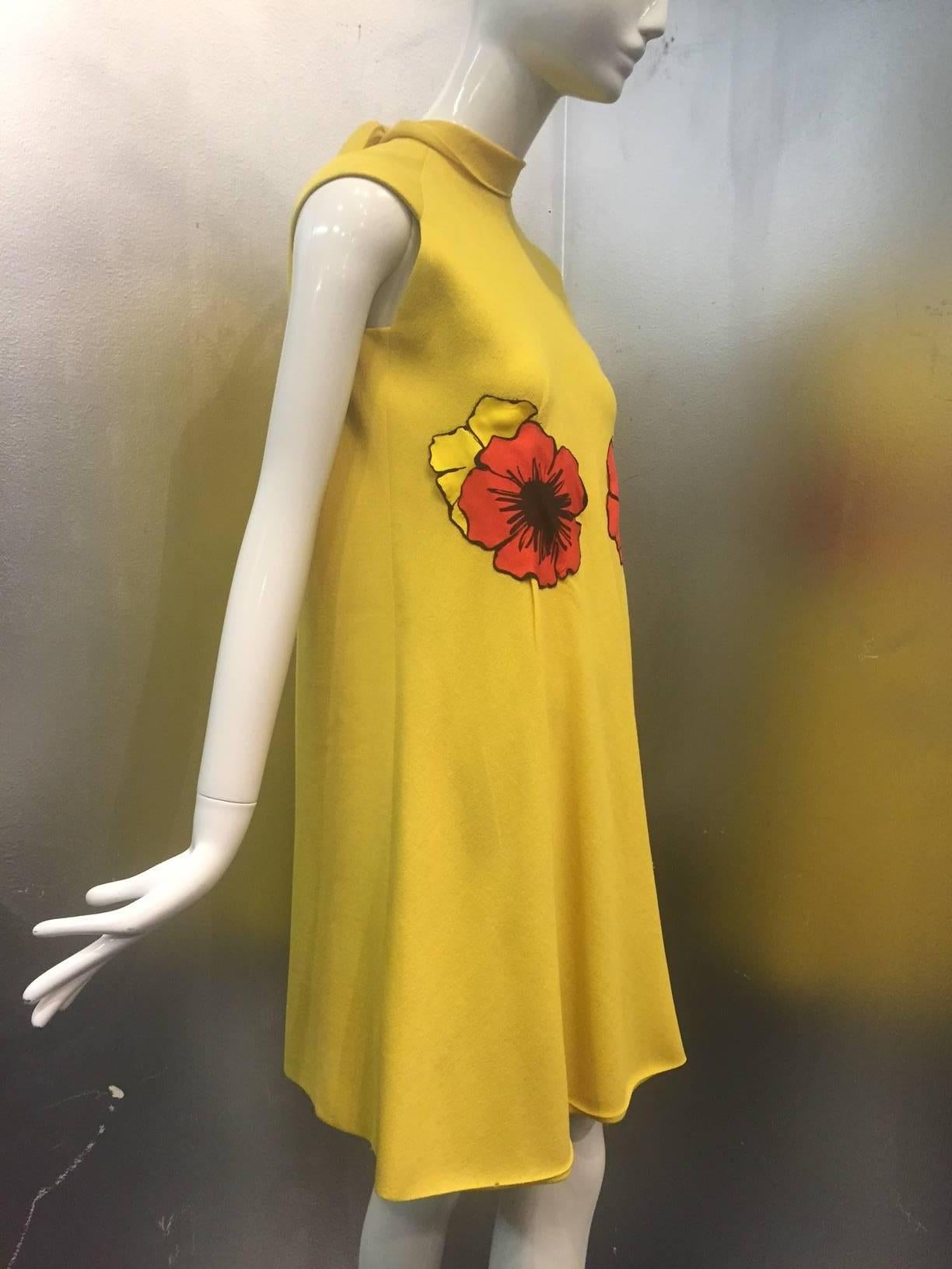 1960s Pauline Trigere lemon yellow lightweight wool crepe trapeze dress with brilliant seaming and construction.   Fully lined.  Silk poppy print appliqués are under bust and also have spaces underneath for a thin yellow belt (not included) at the