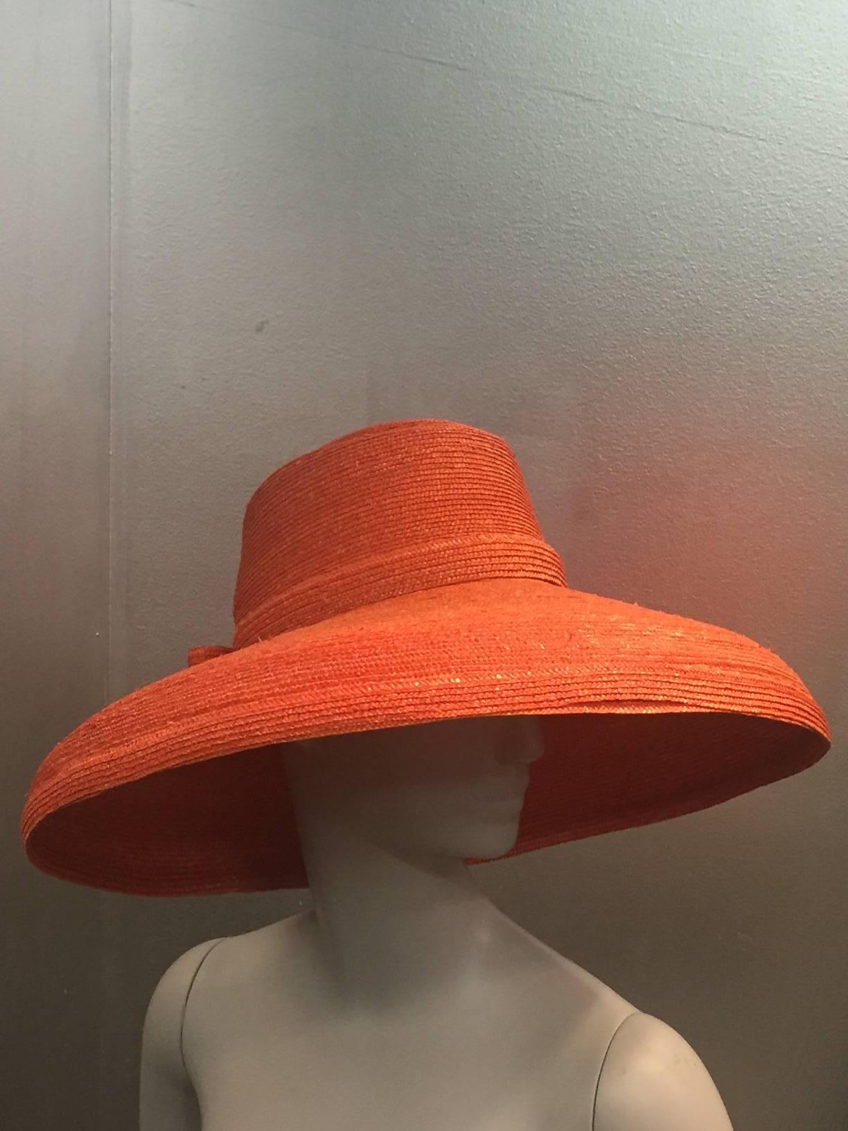 A gorgeous 1960s Frank Olive tangerine straw sun hat with straw braid band and bow.  
