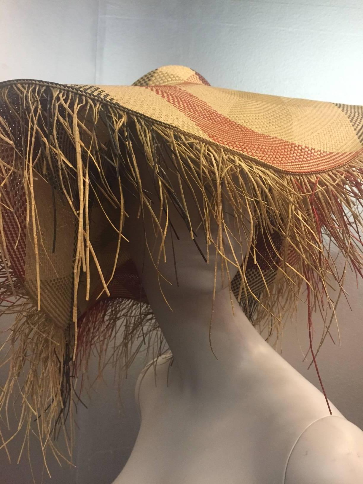 Gorgeous and dramatic 1940s woven plaid straw sun hat with dramatic straw fringed brim.  Colors are navy, olive, burgundy and natural straw.  6.5