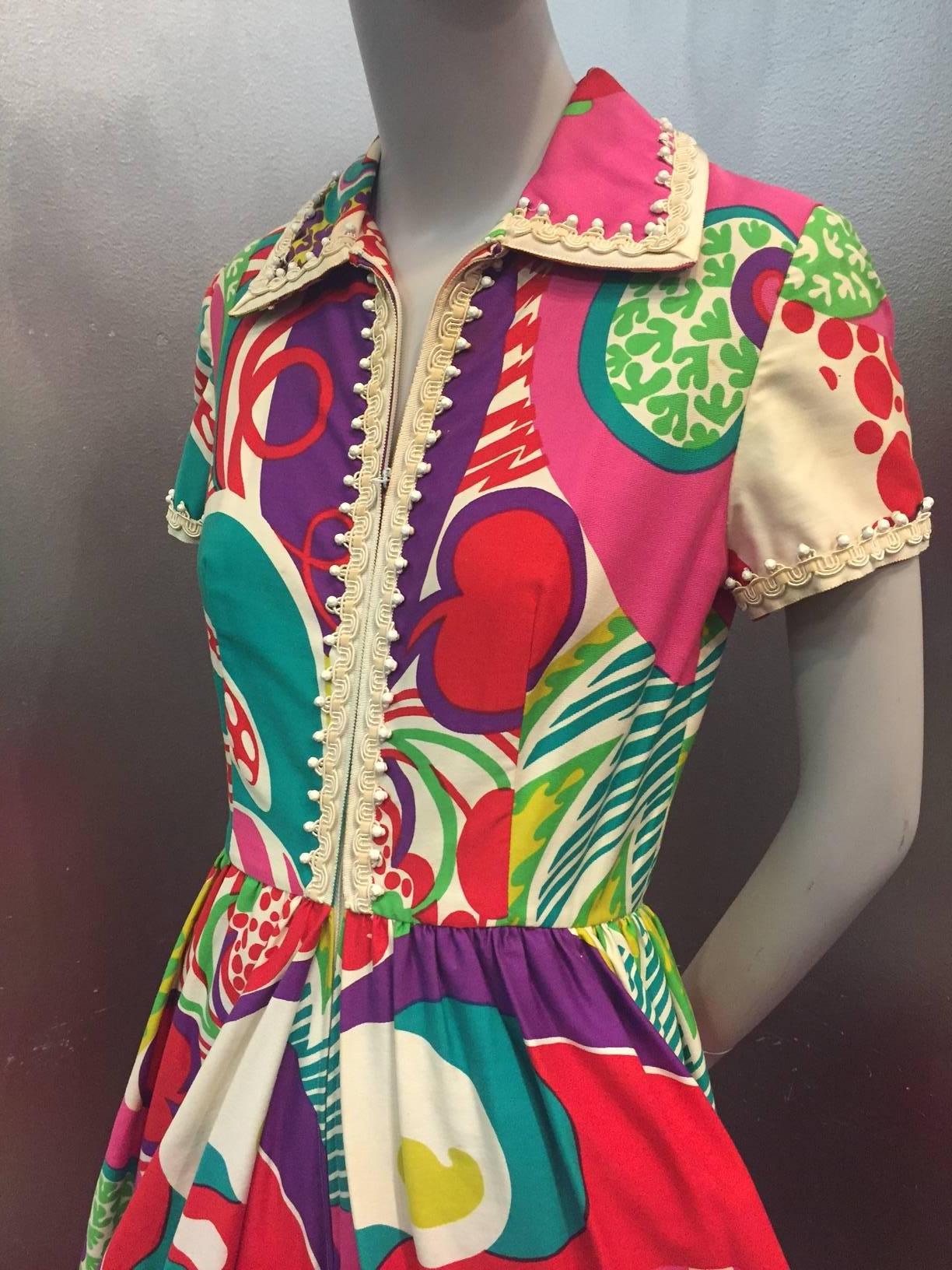 An unmarked but confirmed 1960s Oscar de La Renta abstract pop-art palazzo-legged jumpsuit in white, pink red, green, purple and yellow with zippered front, deeply pleated full legs.  Beautiful and comfortable medium weight cotton. Fully lined with