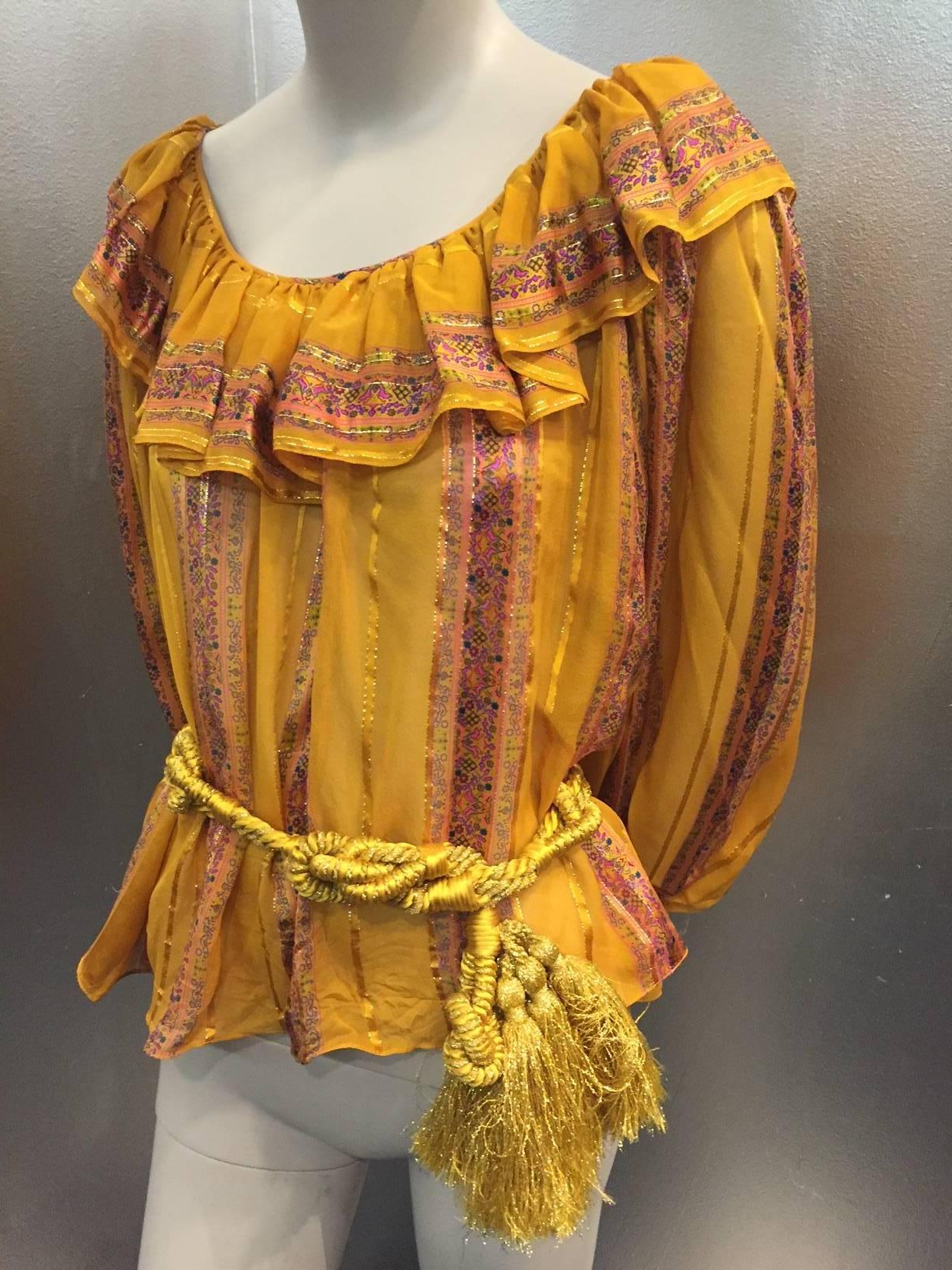 A gorgeous 1970s peasant blouse, no label Oscar de la Renta :  Elastic gathered cuffs and ruffled neckline in semi-sheer silk crepe with floral satin and lamé stripes. Original gold lamé knotted and tasseled cord belt included. 