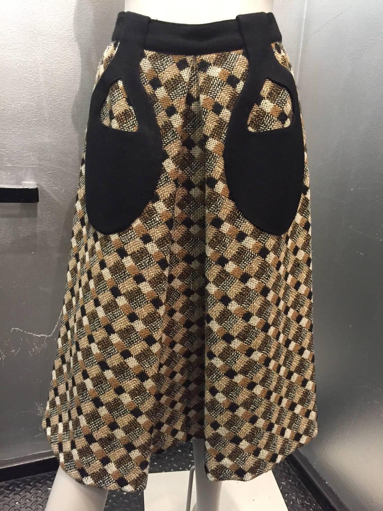 A fantastic 1960s Pierre Cardin black, brown and cream tweed A-line Mod skirt with a deep inverted front pleat and backed jersey teardrop applied patch pockets. 
