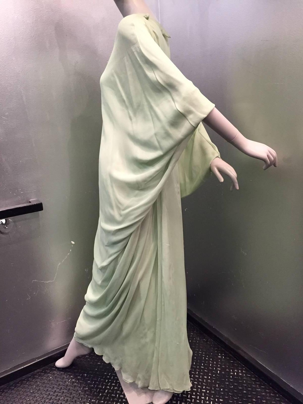 A gorgeous signature 1960s seafoam green 6-layered silk chiffon goddess gown from Stavropoulos!  Meticulously finished hems and gorgeous draping are hallmarks of the Stavropoulos style. Buttons at shoulder. Zippered Back. Fully lined. Sold